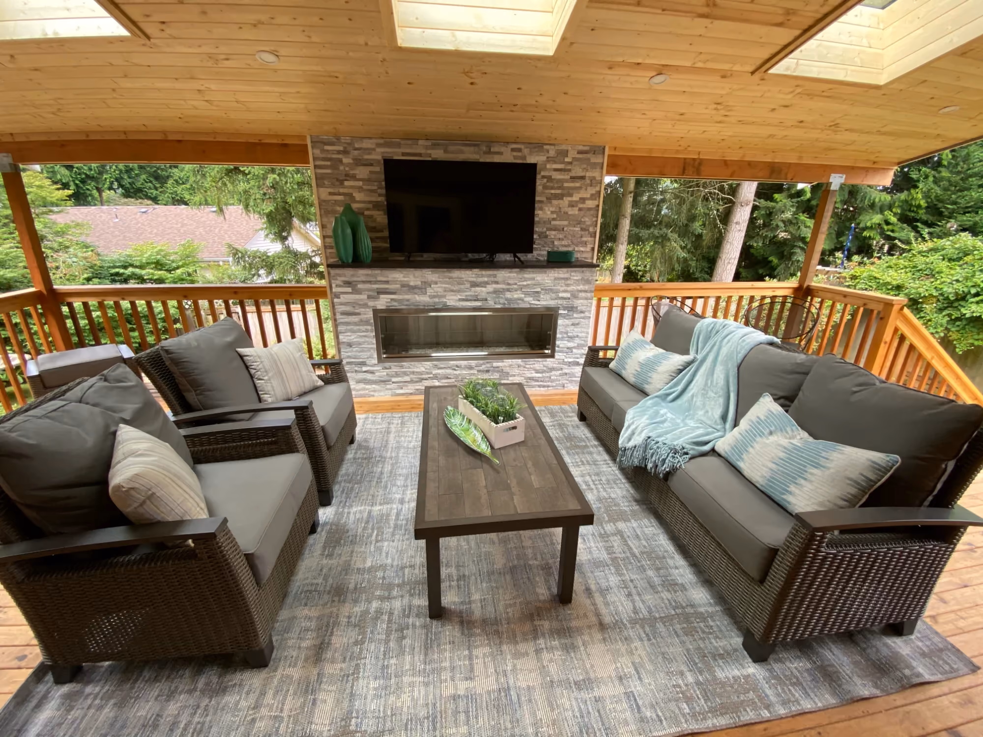 Outdoor patio seating area with cushioned sofas and coffee table