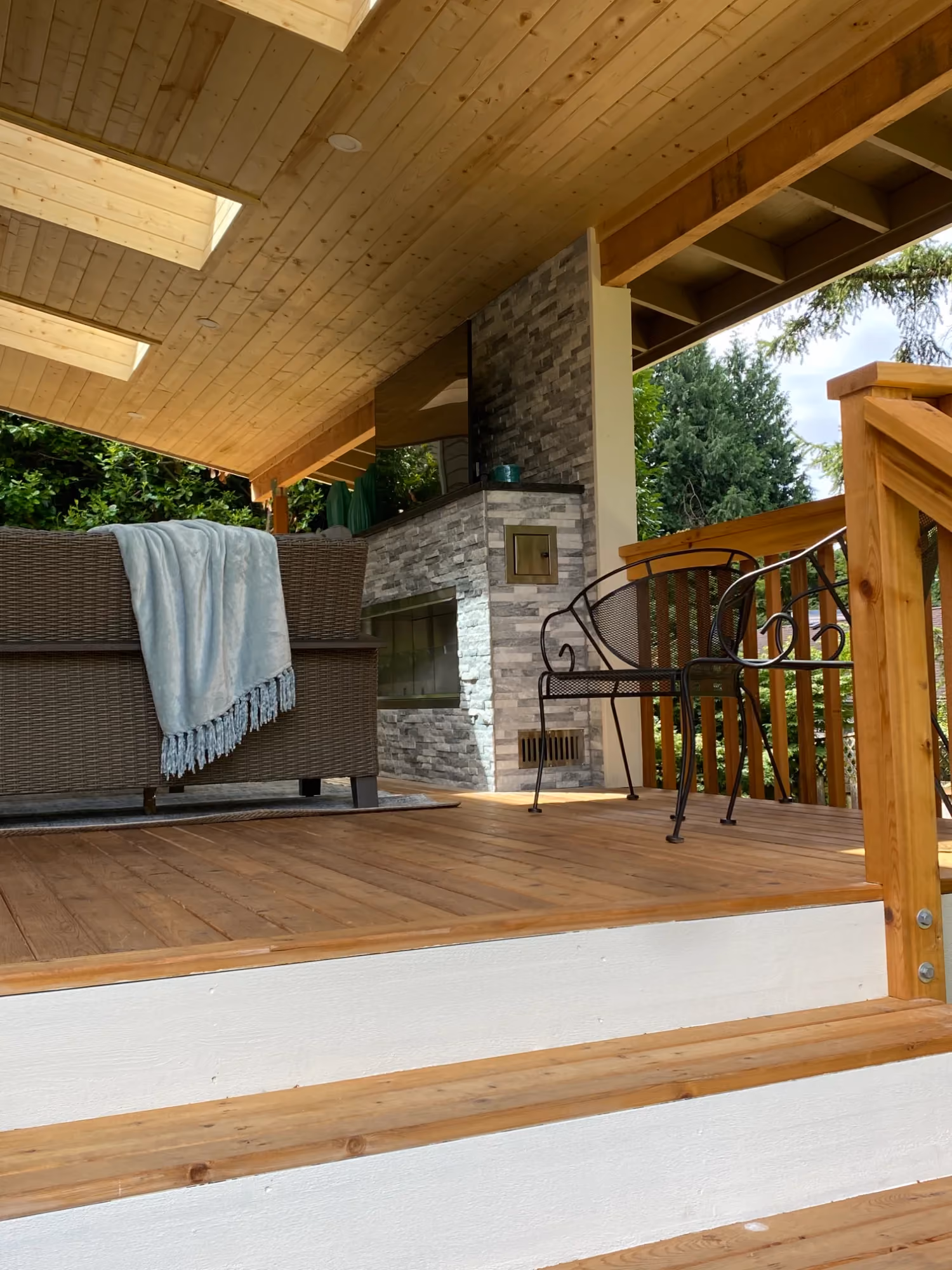 Covered outdoor deck with dining table and chairs