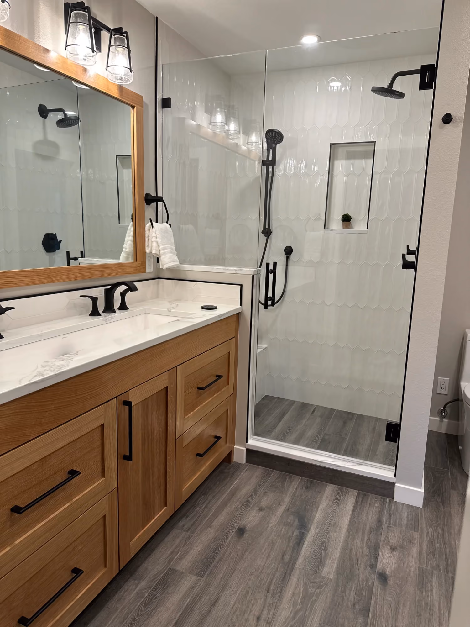 Bathroom vanity with mirror and glass shower