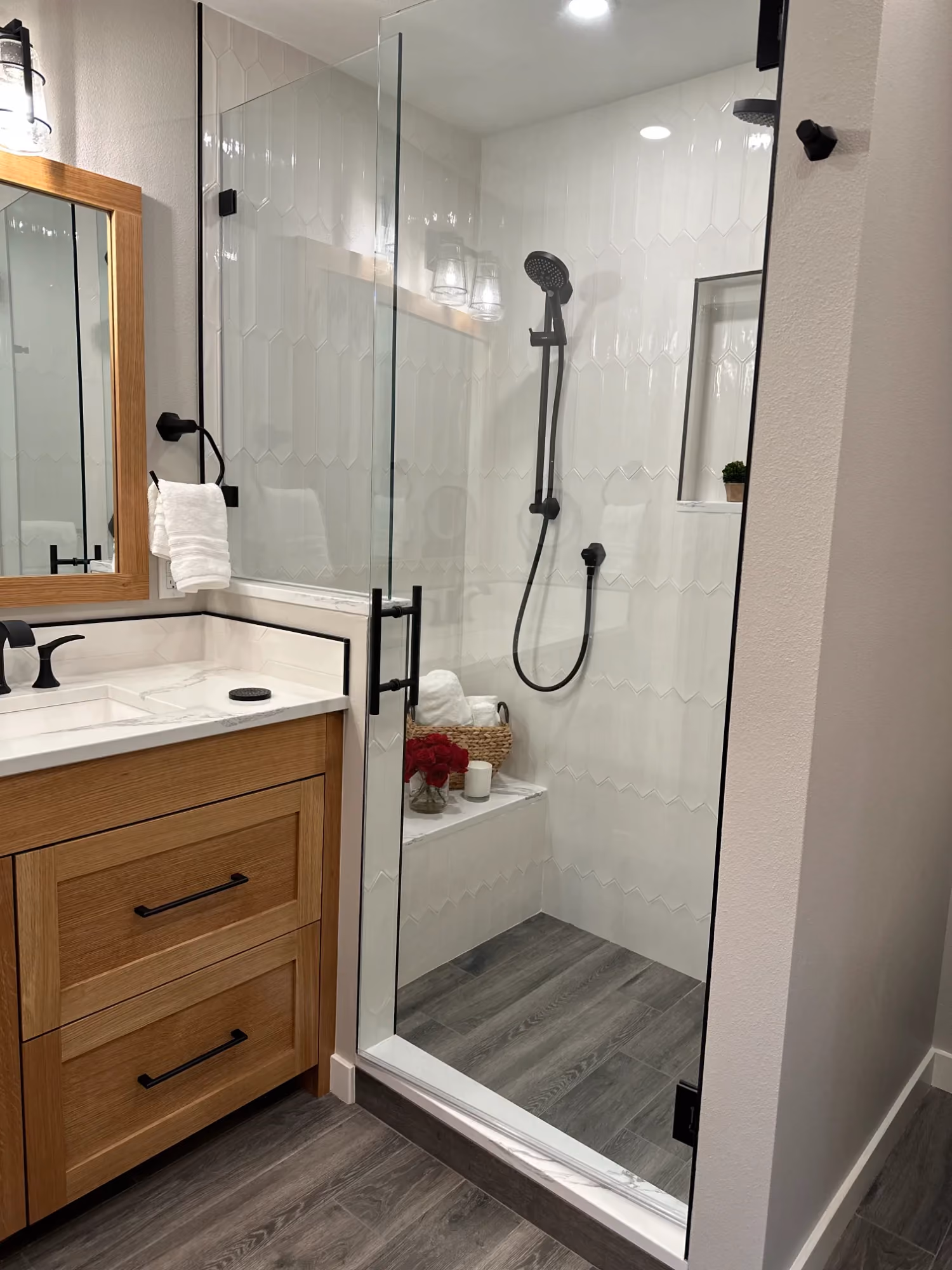 Bathroom vanity and glass shower with tiled floor