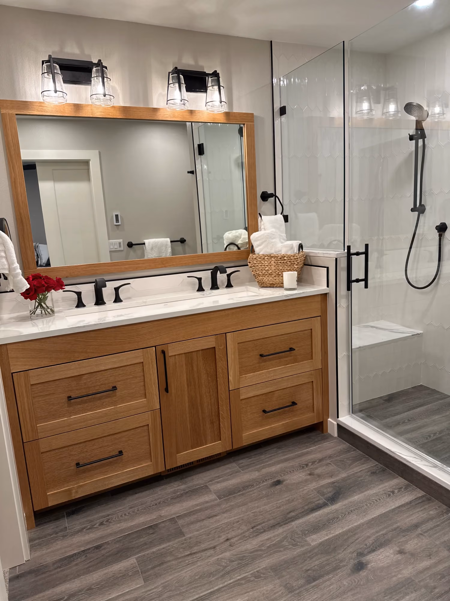 Double-sink vanity with wooden cabinets and mirrors
