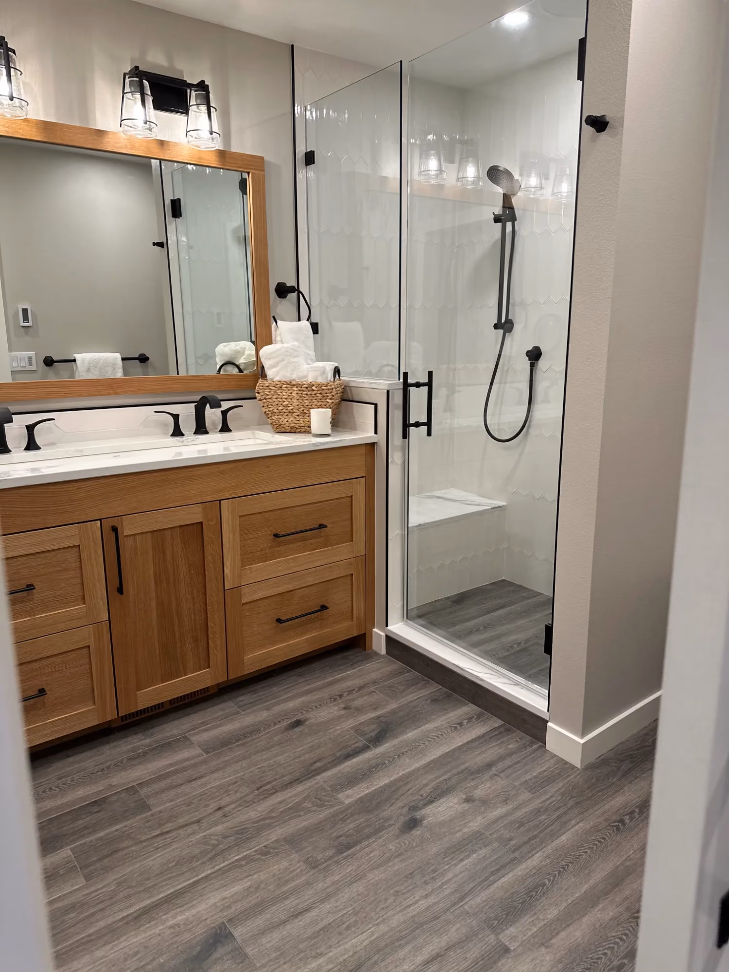 Bathroom vanity and walk-in shower with glass door
