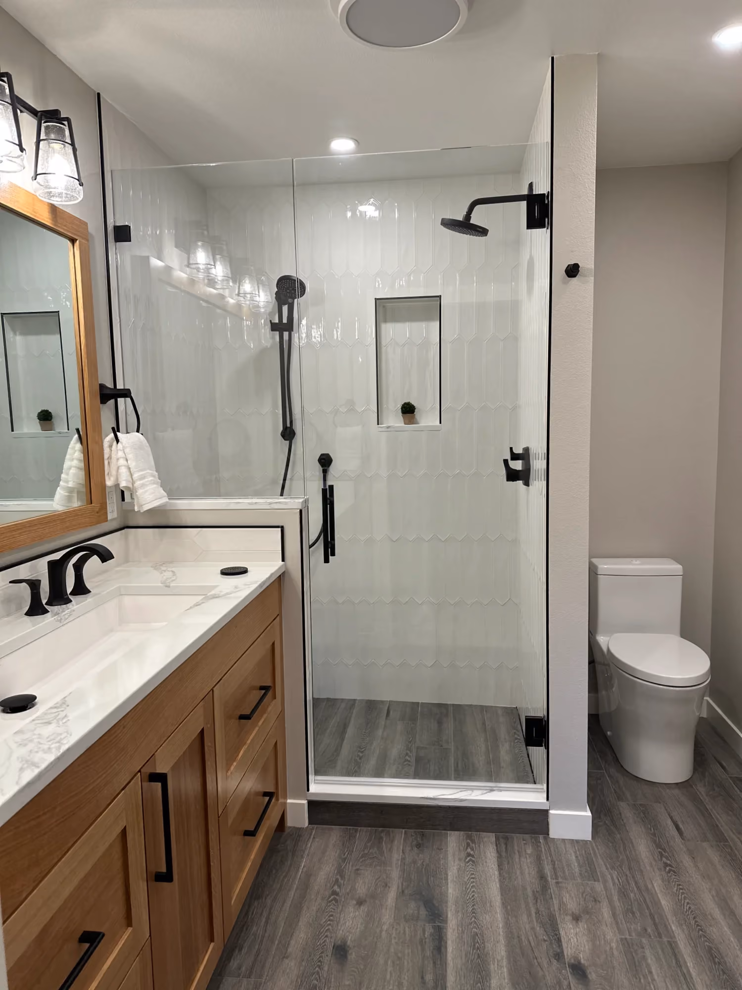 Narrow bathroom vanity with mirror and toilet