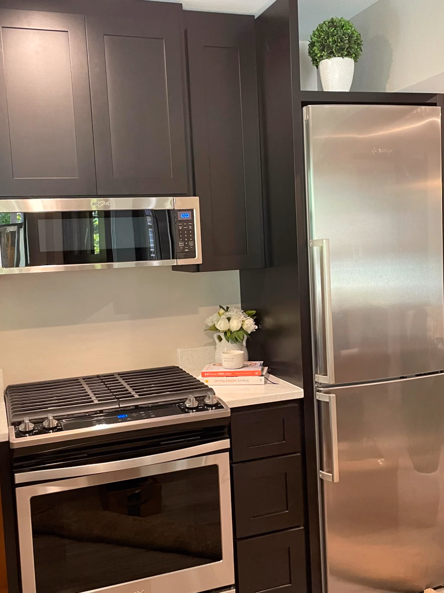 Kitchen area with stainless steel refrigerator and stove