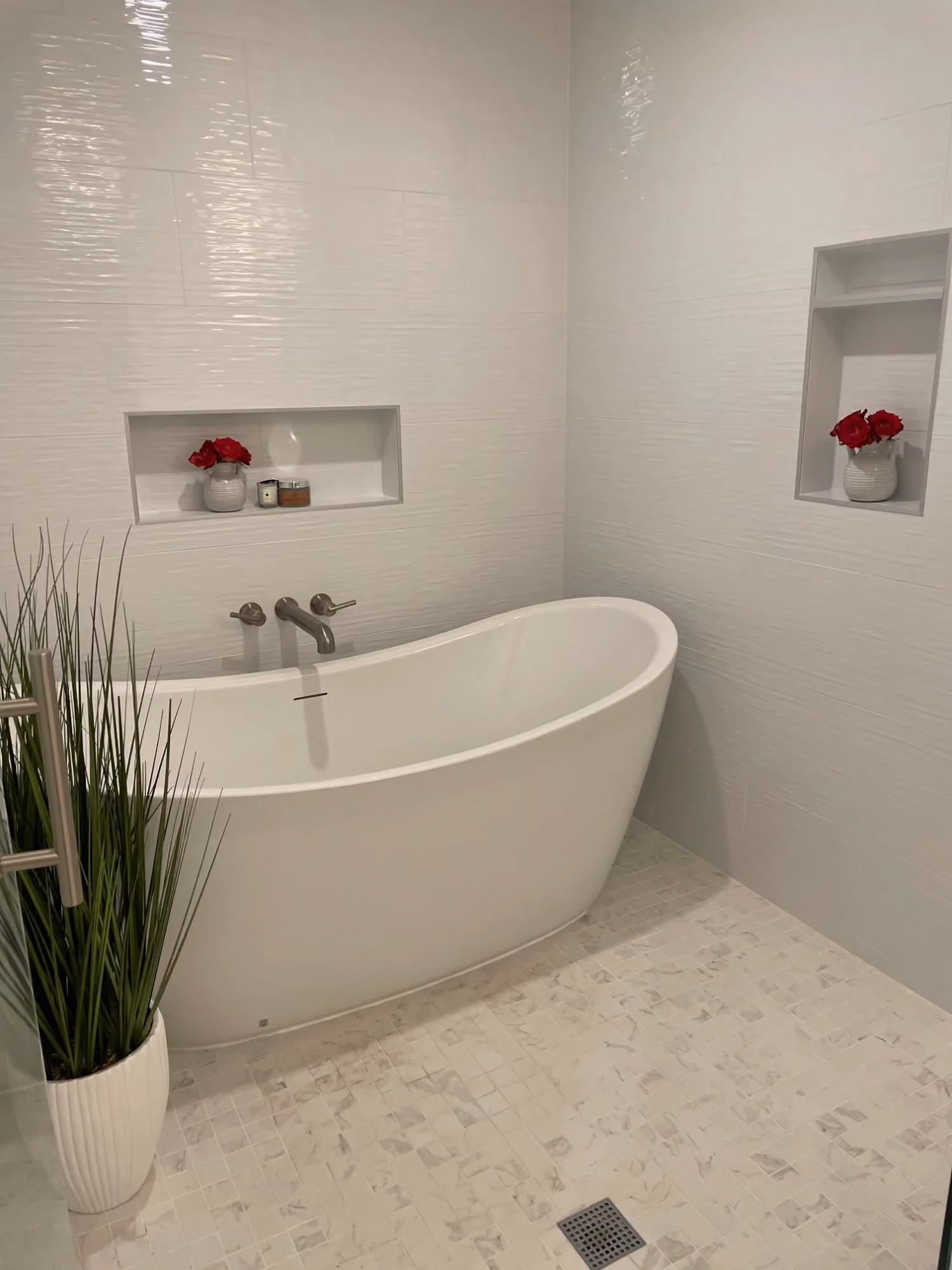 Freestanding bathtub in a bright tiled bathroom
