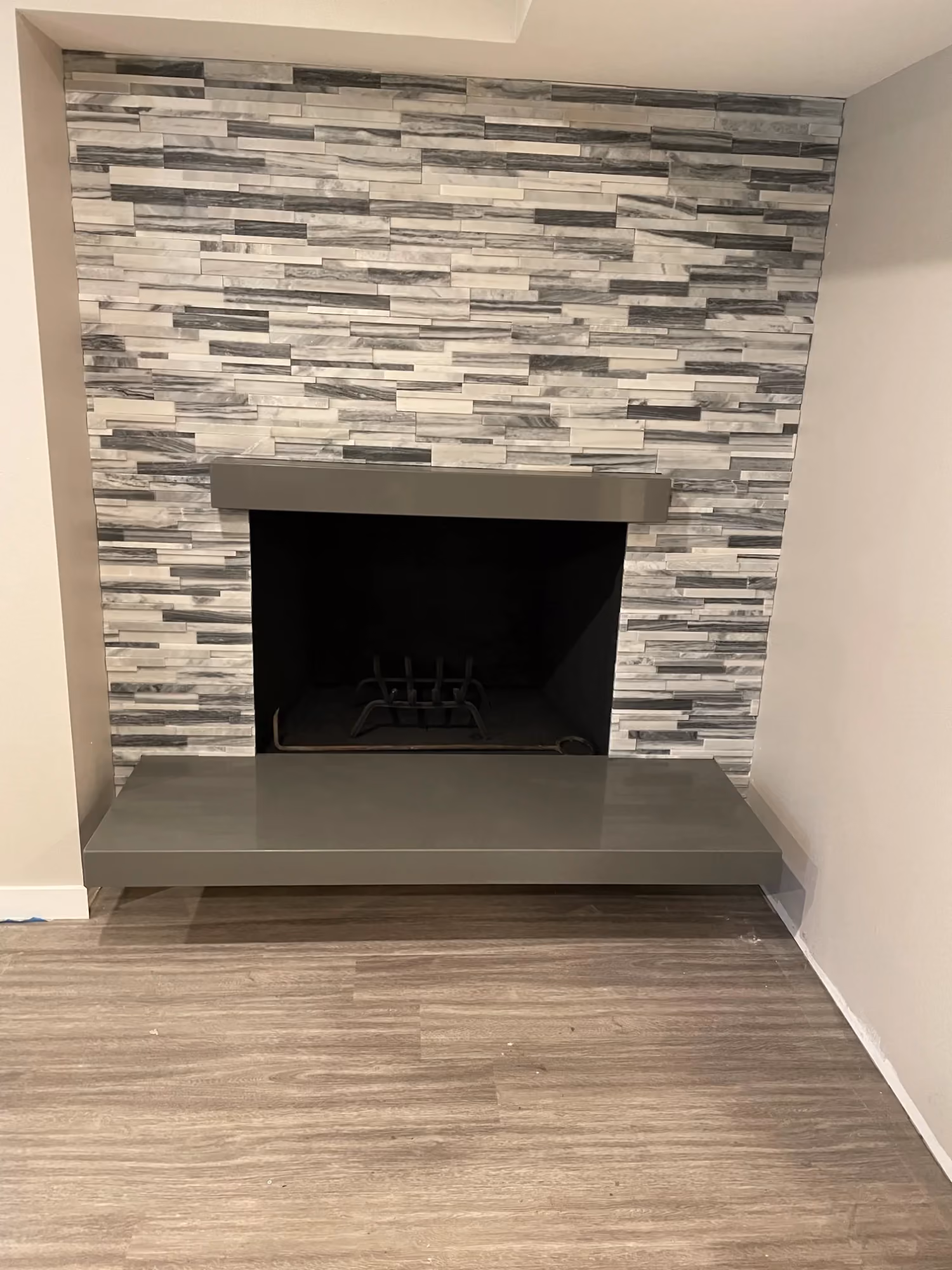 Stone-tile fireplace surround with black firebox