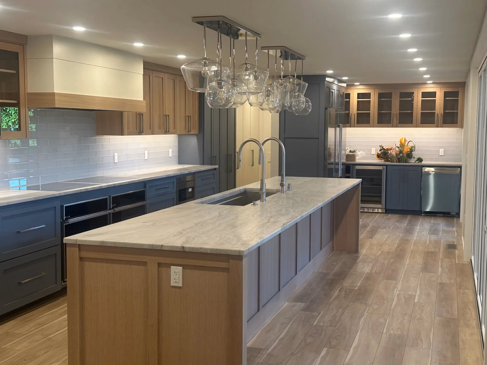 Contemporary kitchen with large island and pendant lights