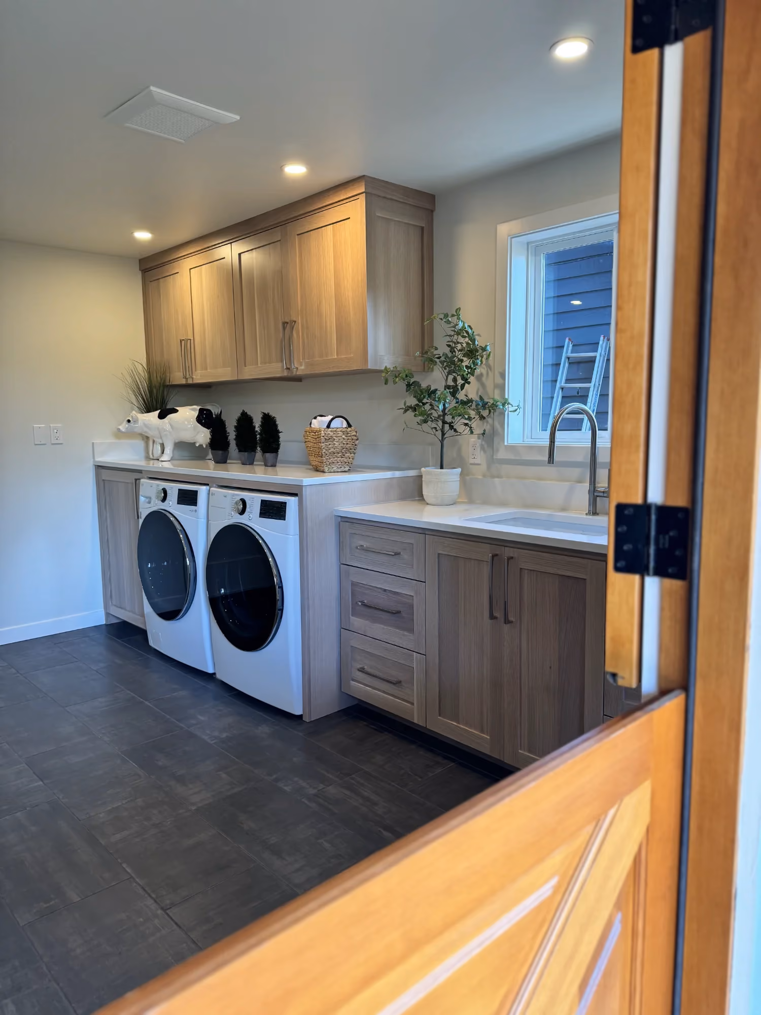 Laundry room with washer, dryer, and sink