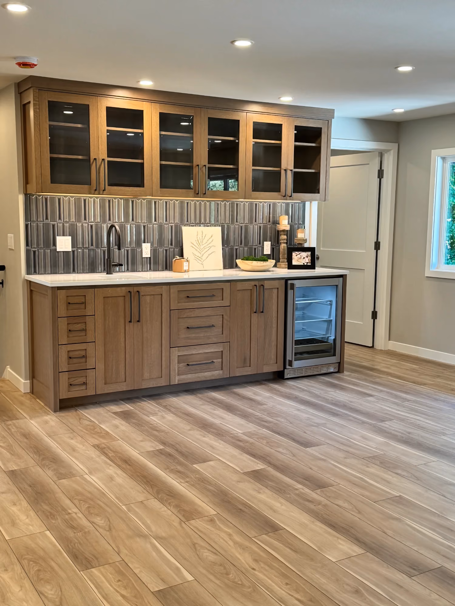 Wide view of kitchen and dining space with wood floors