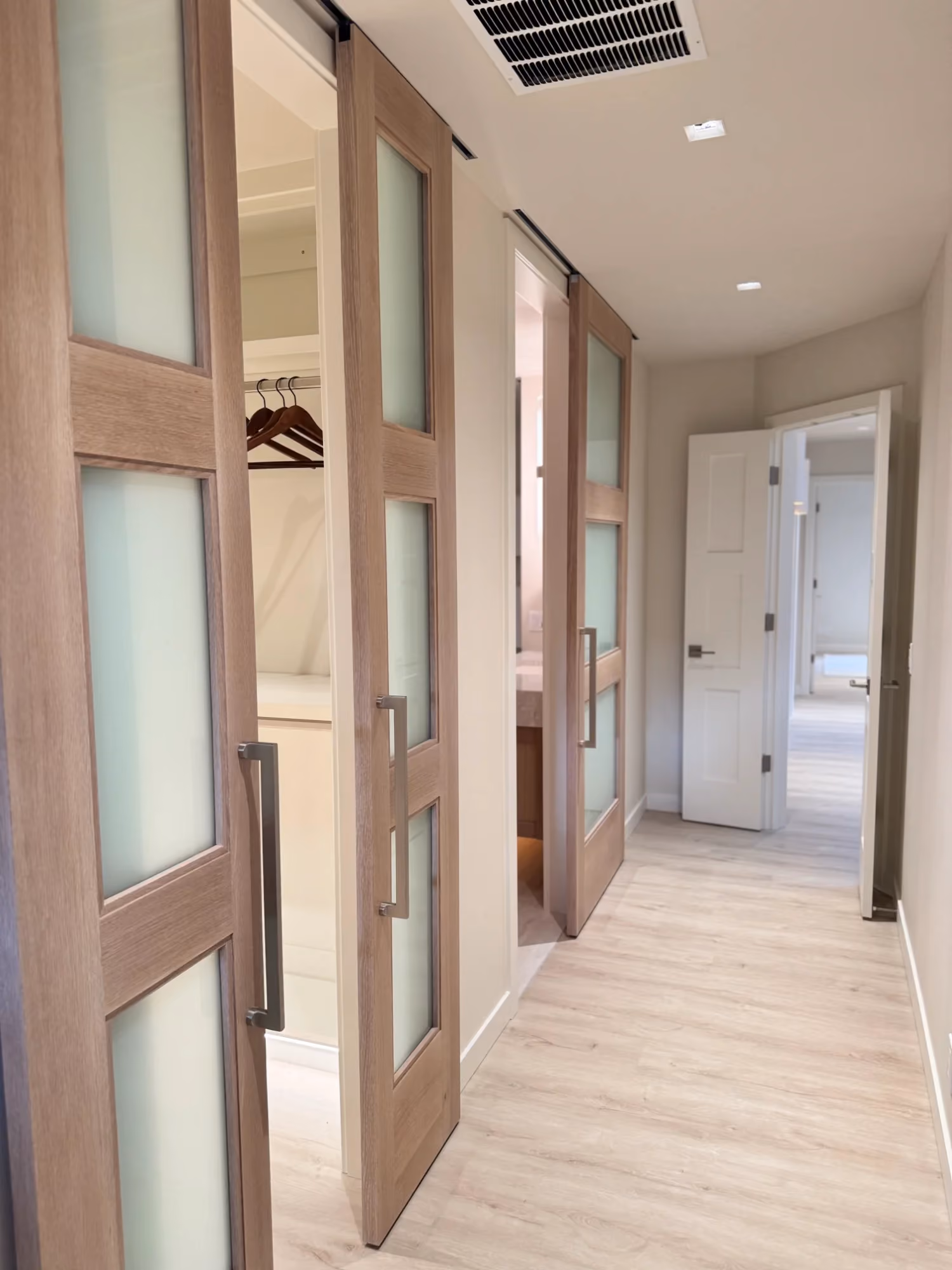 Hallway with wood floors and doorways