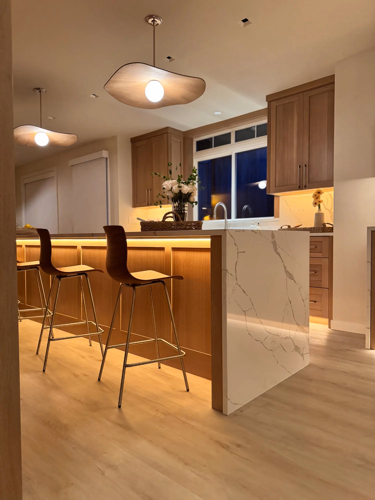 Modern kitchen with bar seating and pendant lights