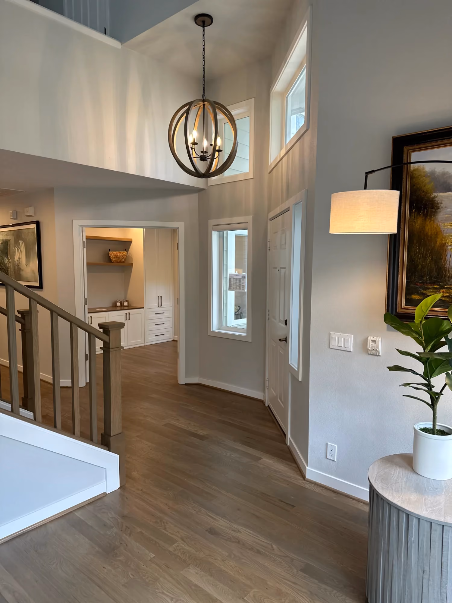 Bright hallway with white wainscoting and hardwood floors