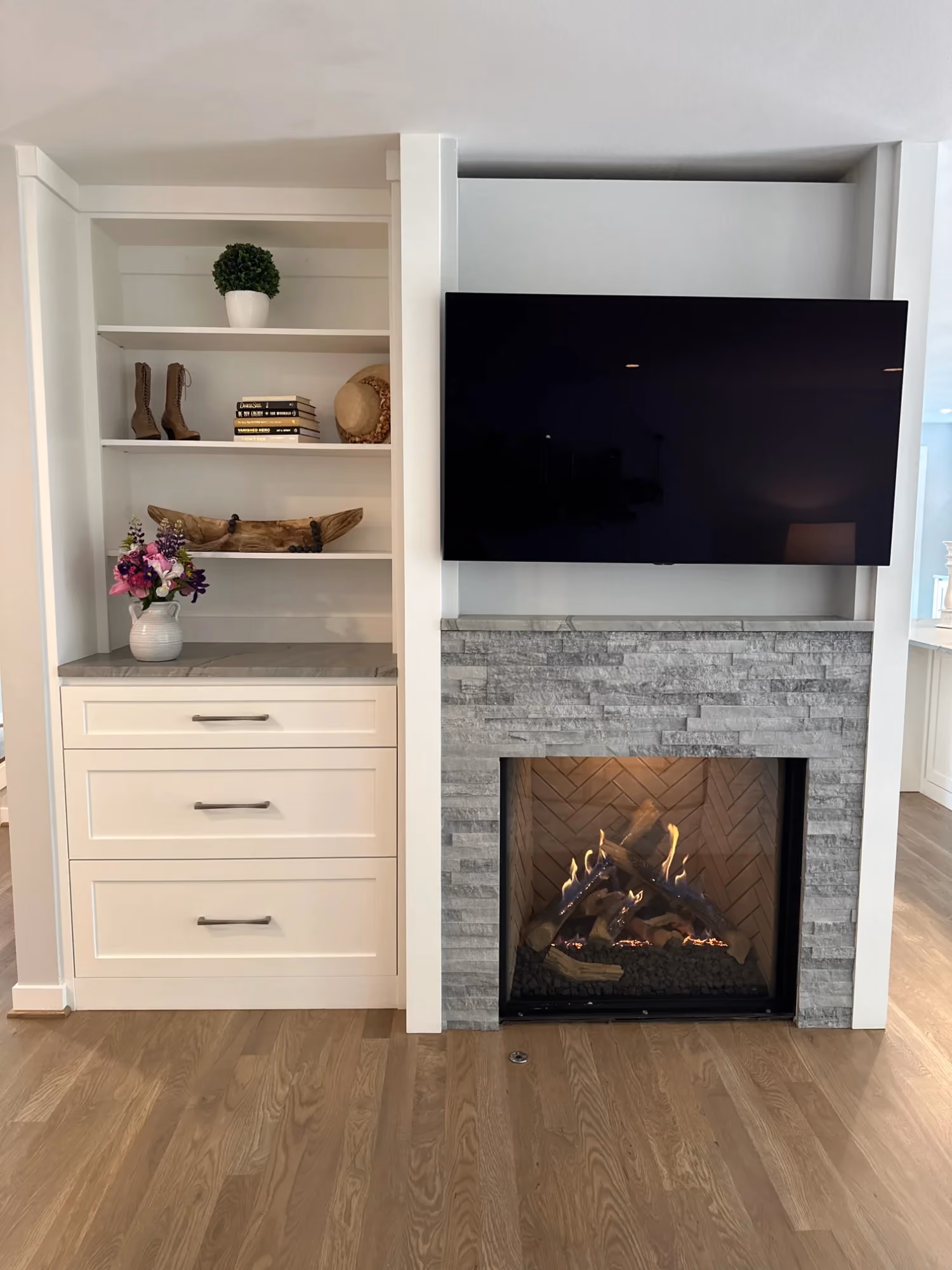 Built-in shelves with TV above a fireplace
