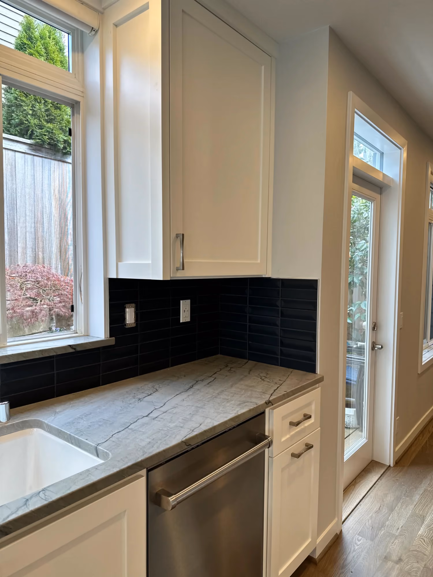 Kitchen corner with countertop, cabinets, and window