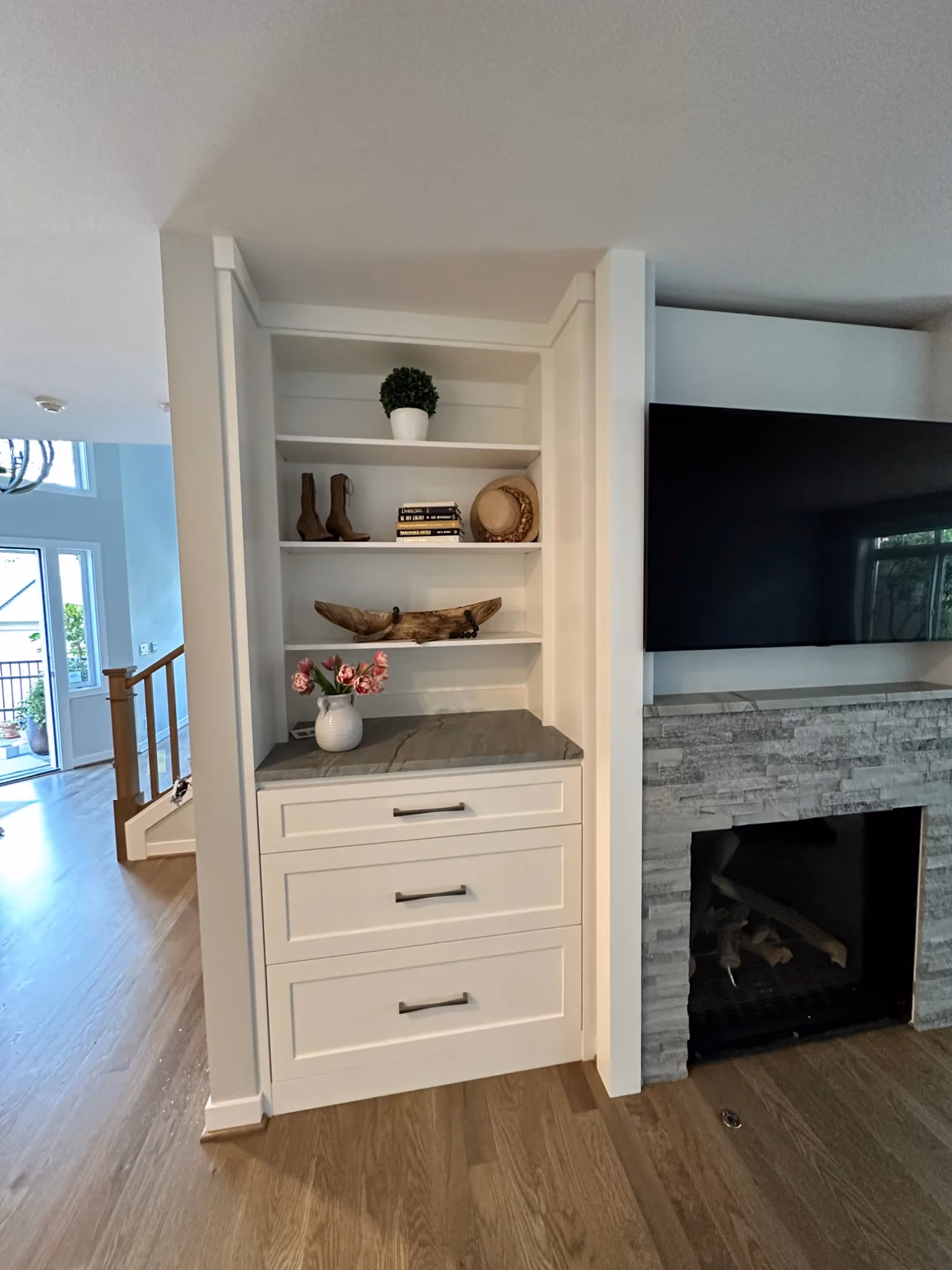 Built-in shelves and cabinets beside fireplace