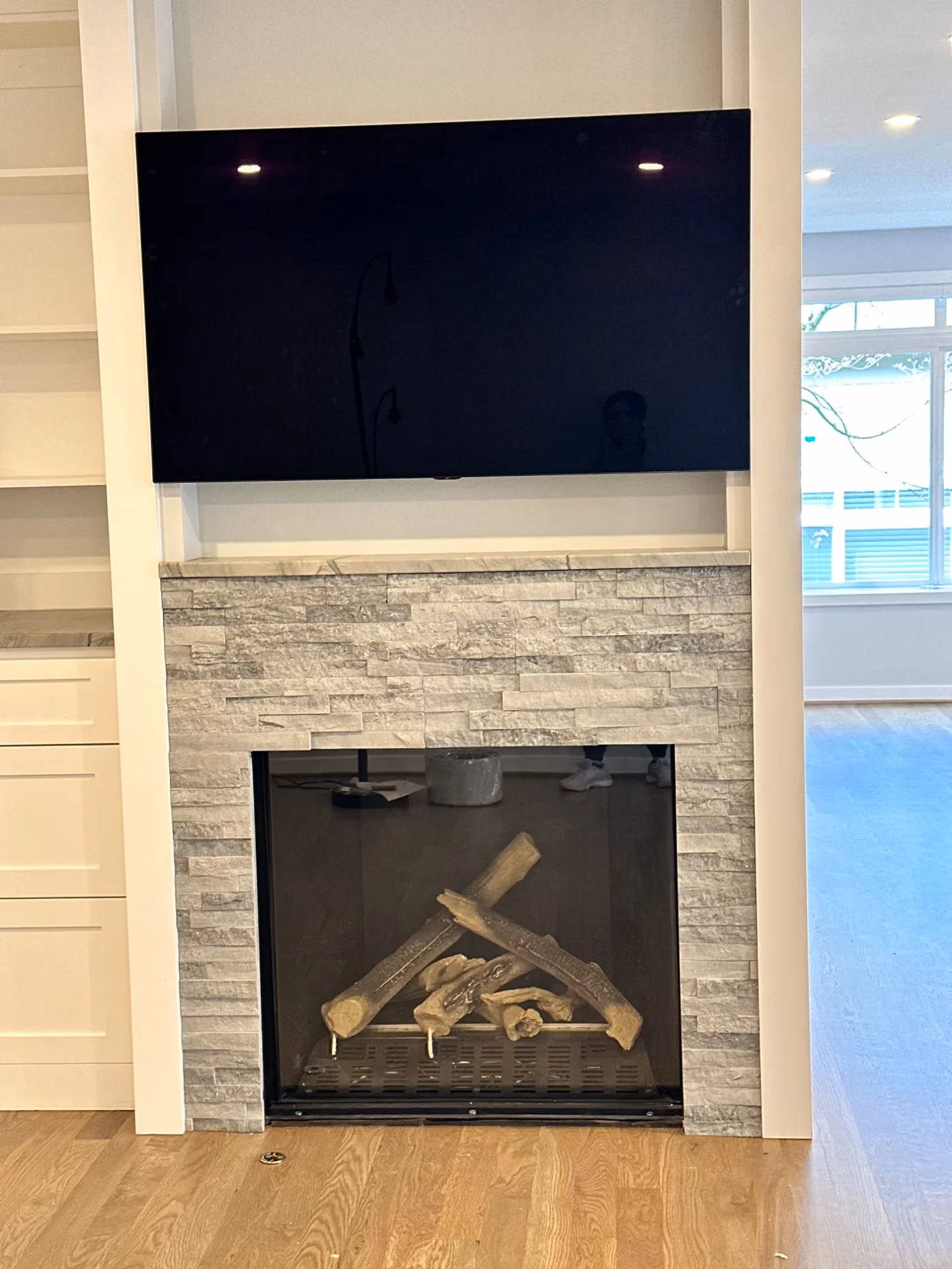 Close-up of fireplace with wall-mounted TV above