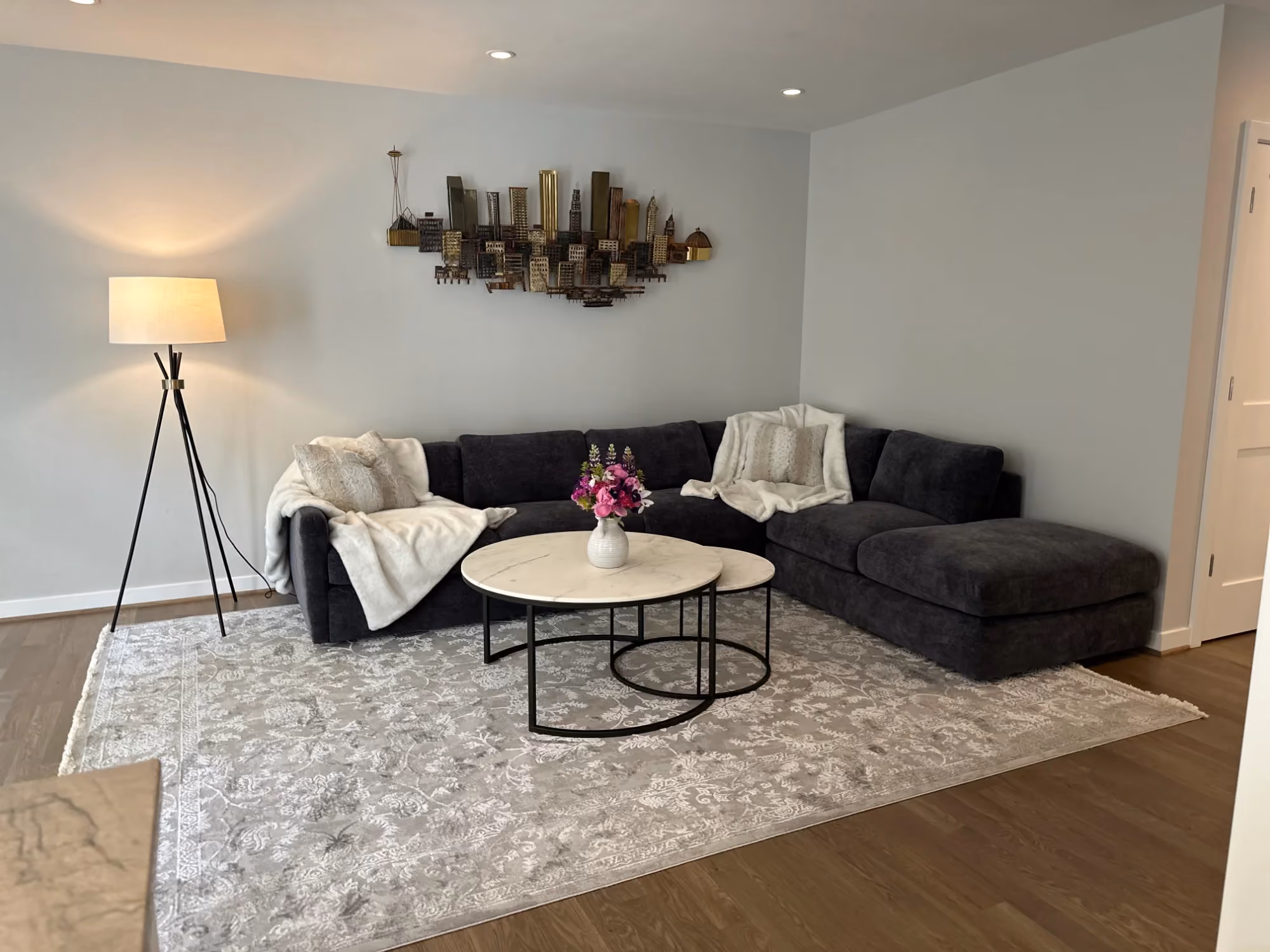 Living room with sectional sofa, floor lamp, and coffee table