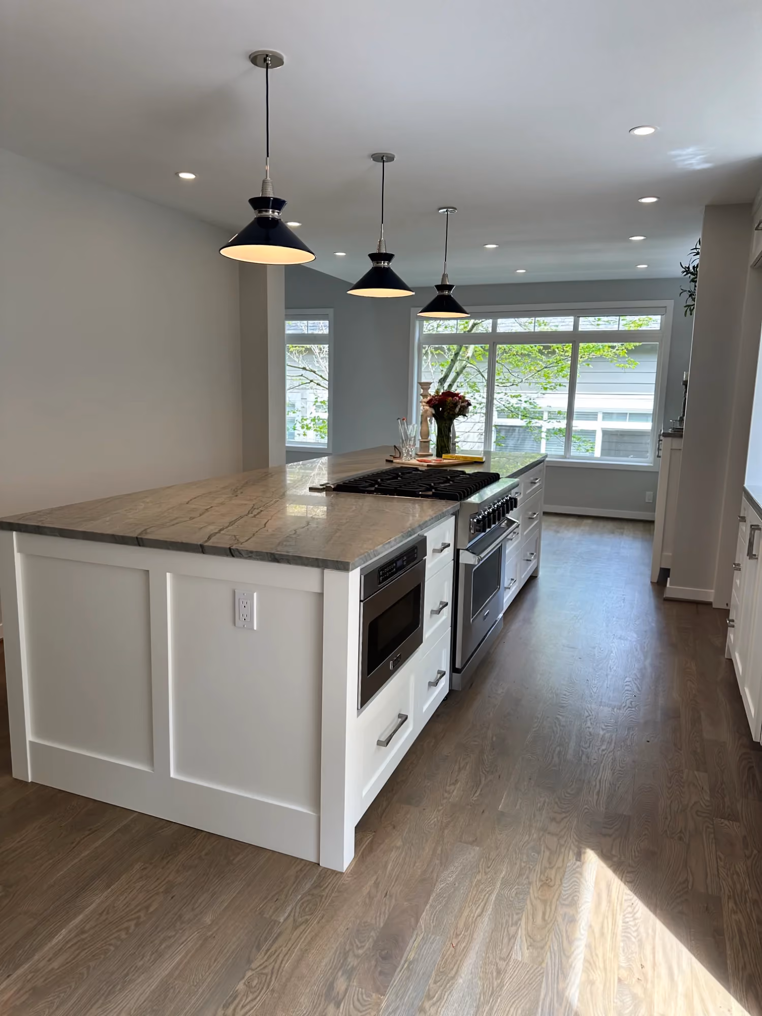 Modern white kitchen with island and pendant lights