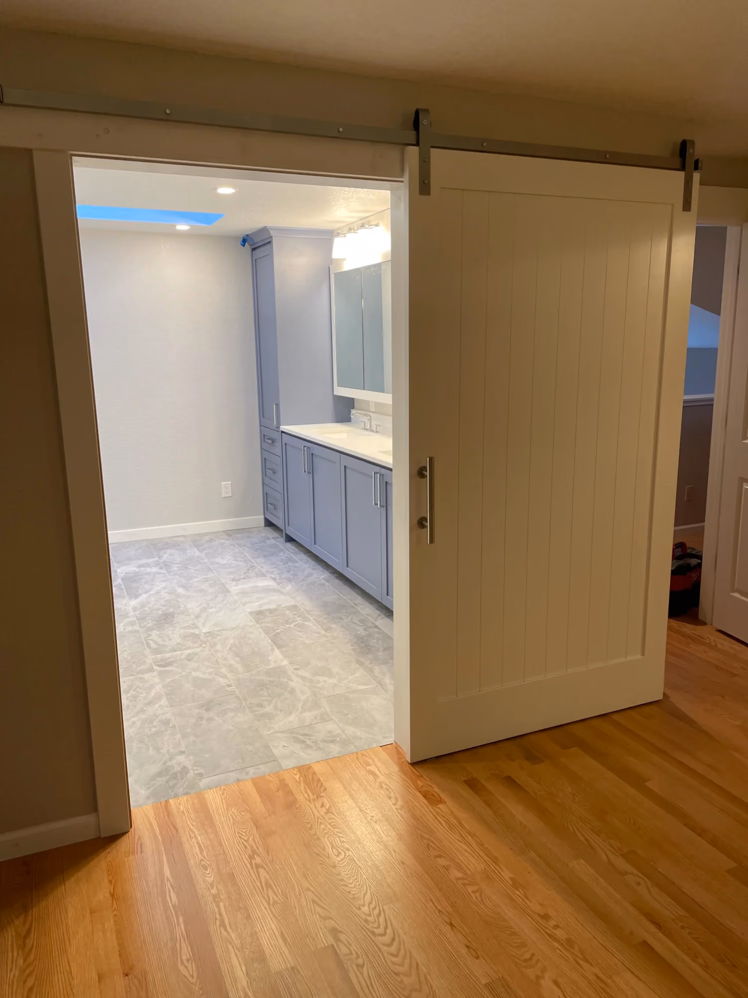 Hallway with open doorway and tiled floor