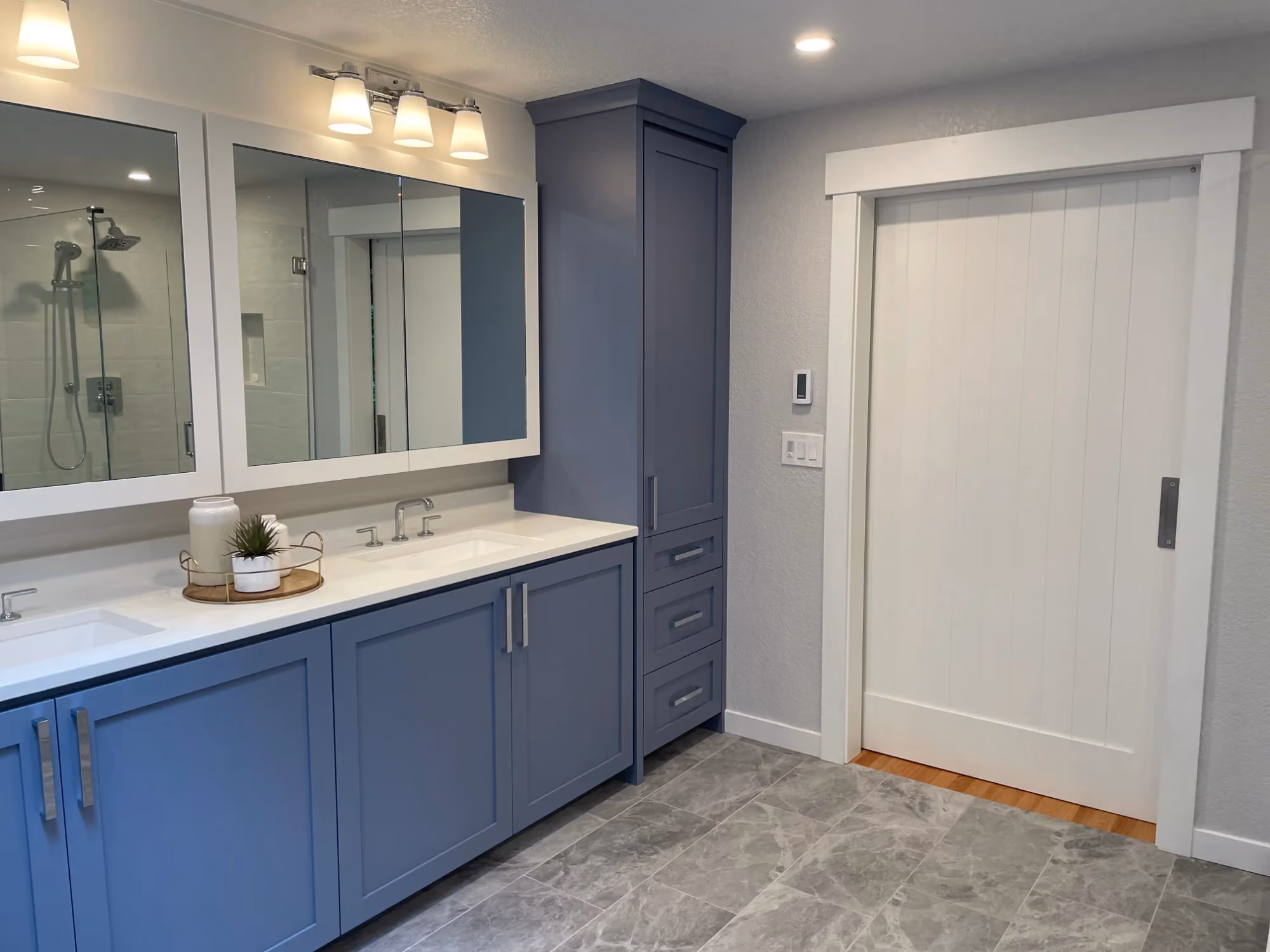 Blue double vanity with large mirror in modern bathroom