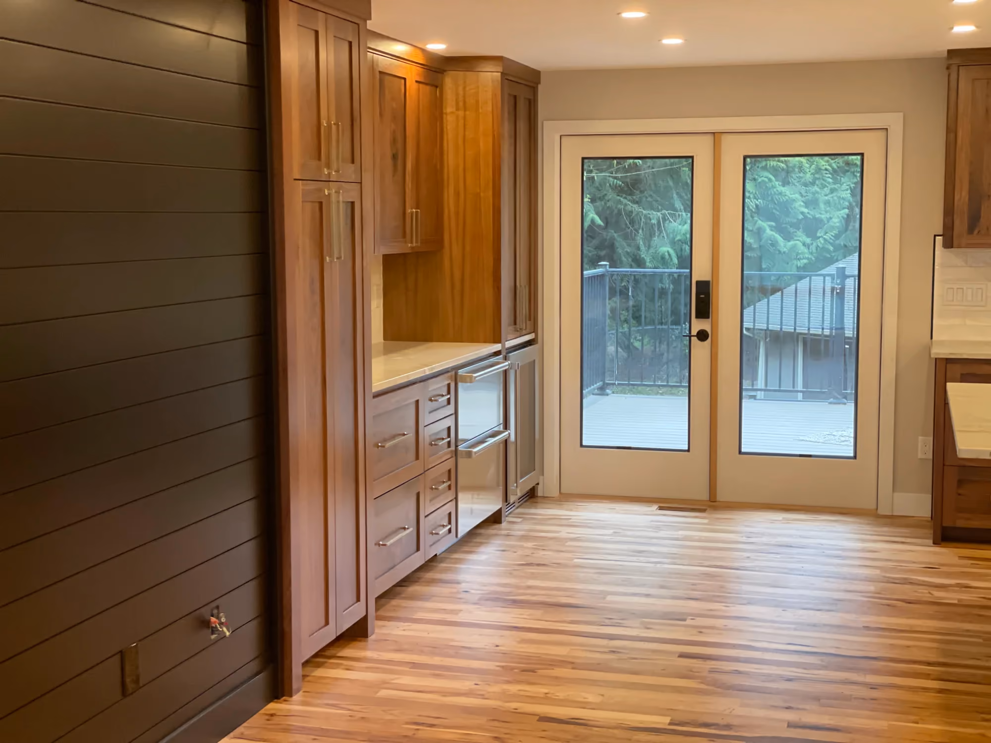 Wood-paneled hallway with French doors and console sink