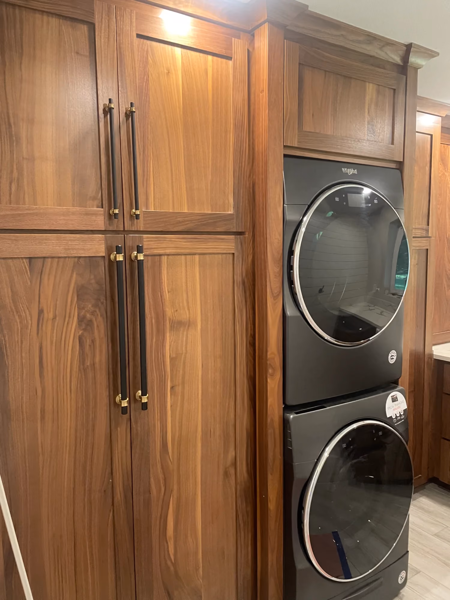 Stacked washer and dryer in wood cabinet closet