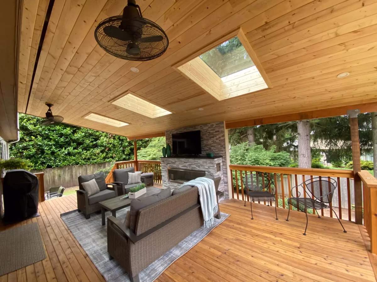 Covered patio with outdoor lounge seating and ceiling fan