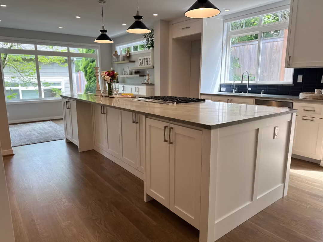 Bright kitchen with white island and bar stools