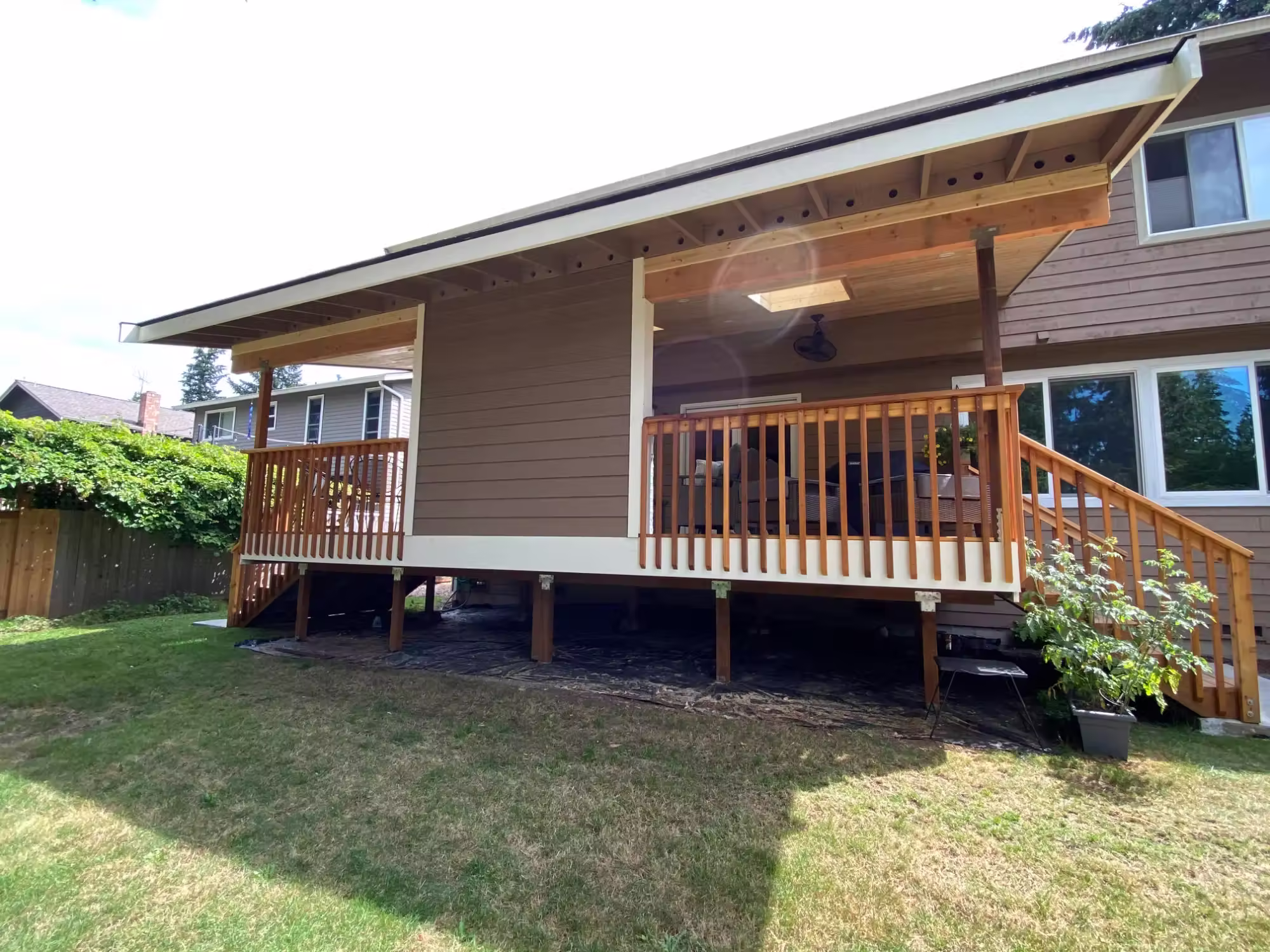 House exterior view with raised wooden deck