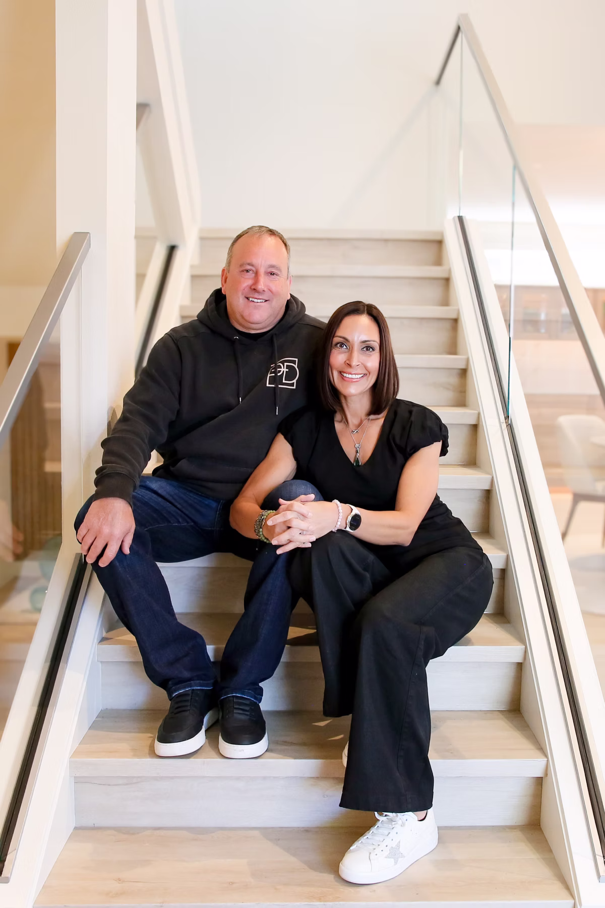 Couple sitting on staircase in home