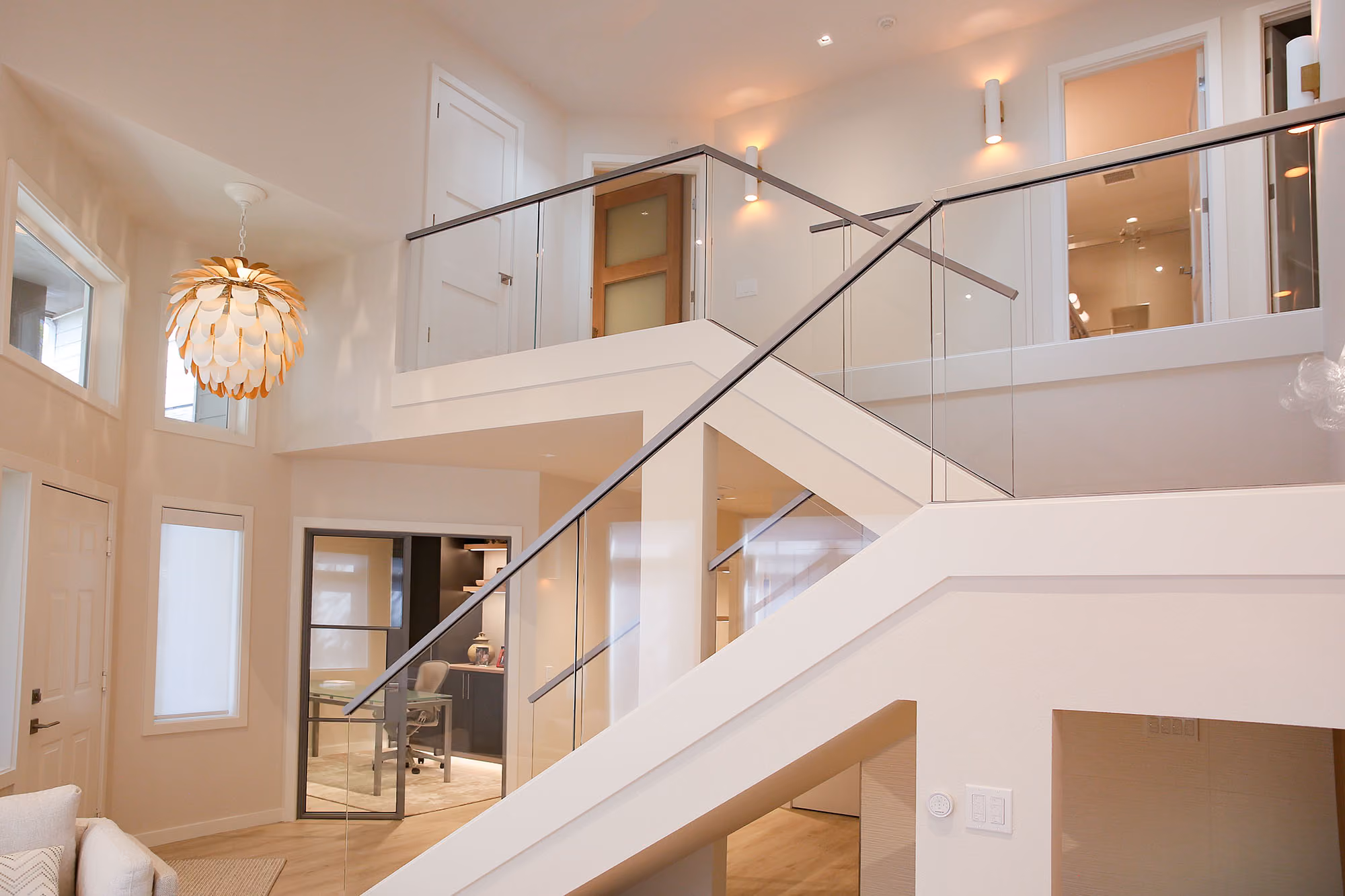 Bright home interior with staircase and railing