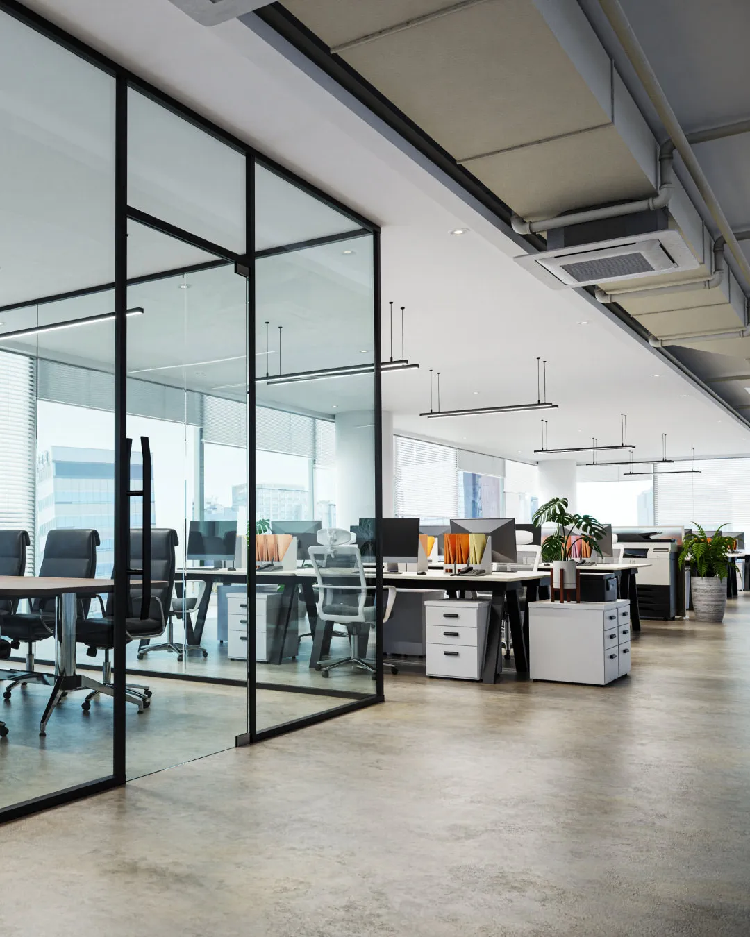Modern open office with glass meeting room, black chairs, desks with computers, and indoor plants.