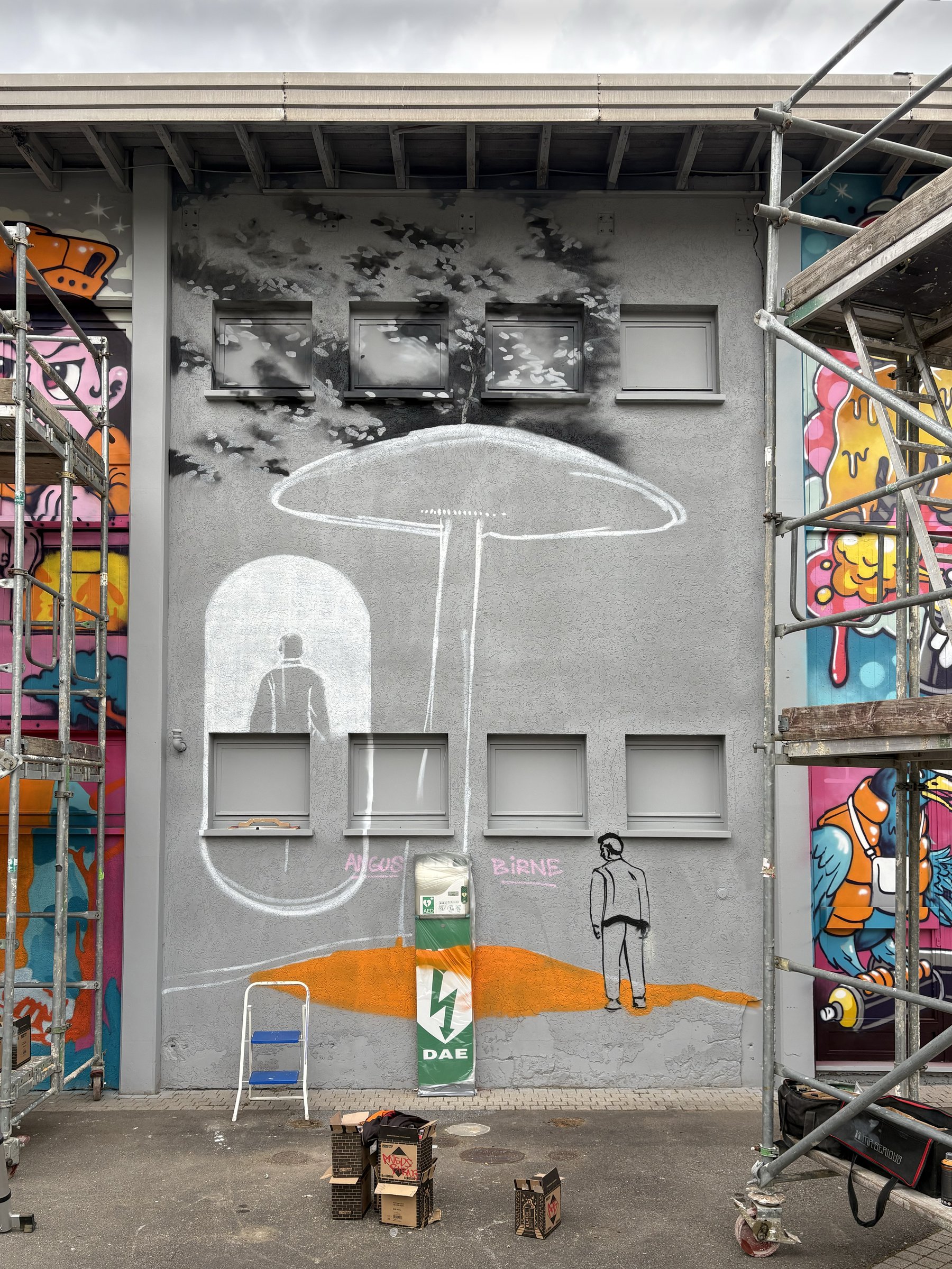 Process stage of the Kopstal mural with scaffolding and underpainting