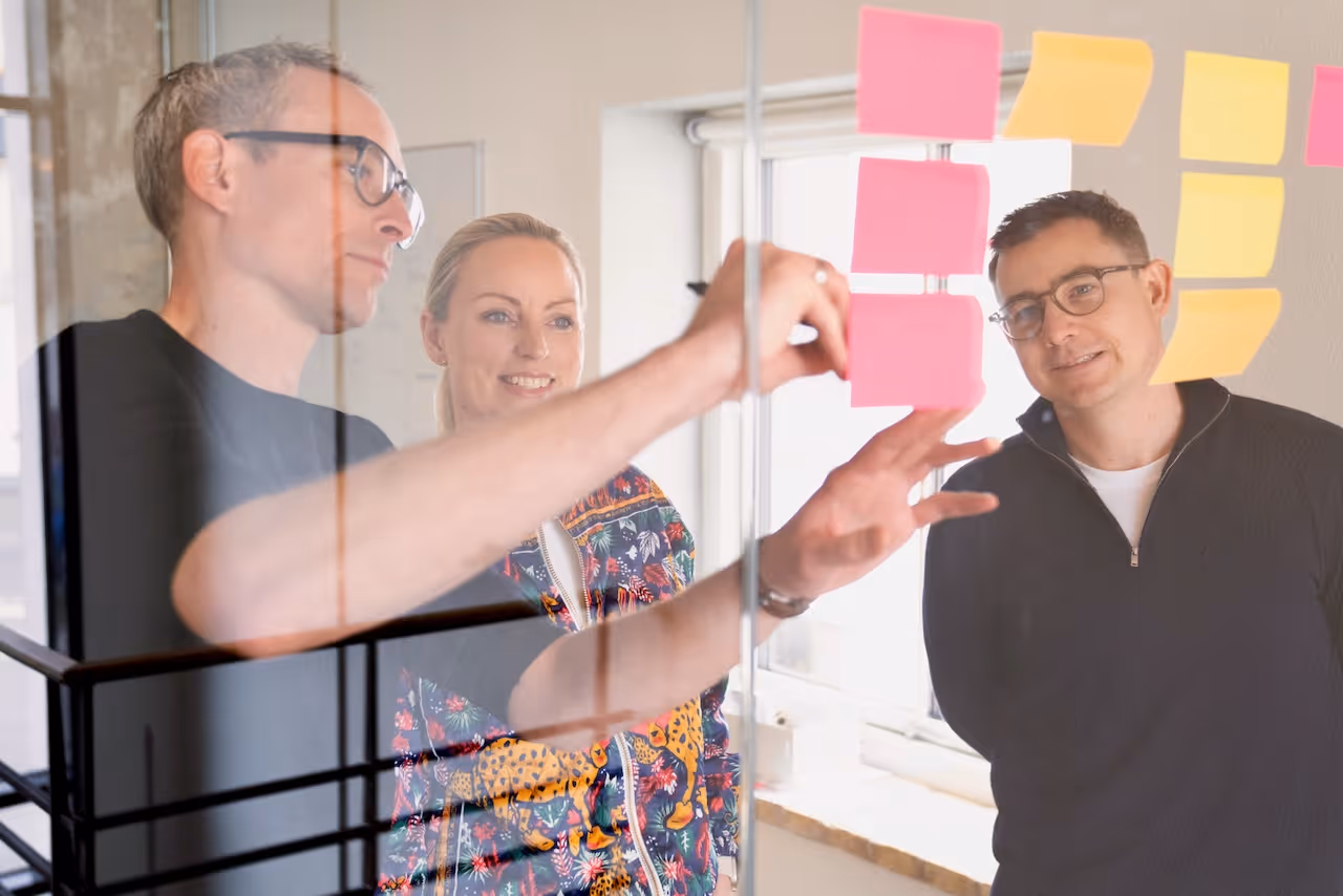 3 people looking at post-its