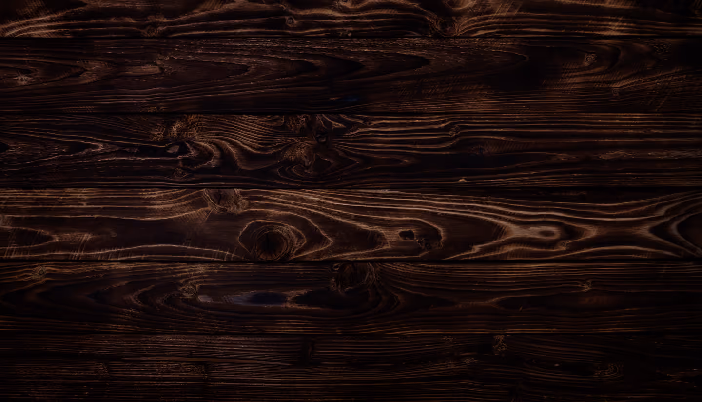 Dark stained wooden planks with visible wood grain and knots creating a textured surface.