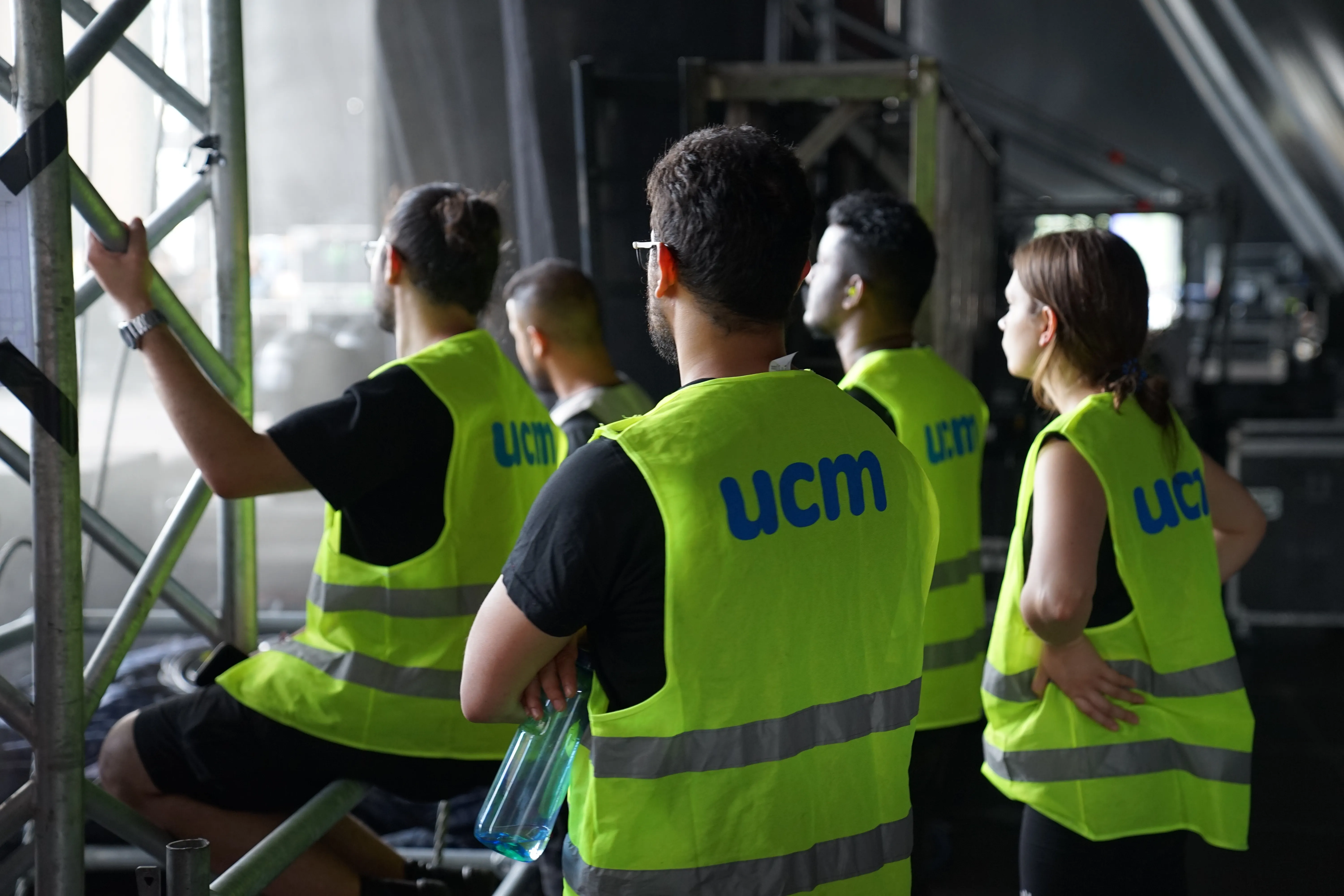 Event crew in ucm hi-vis vests during set-up - staff booked at short notice for summer assignments