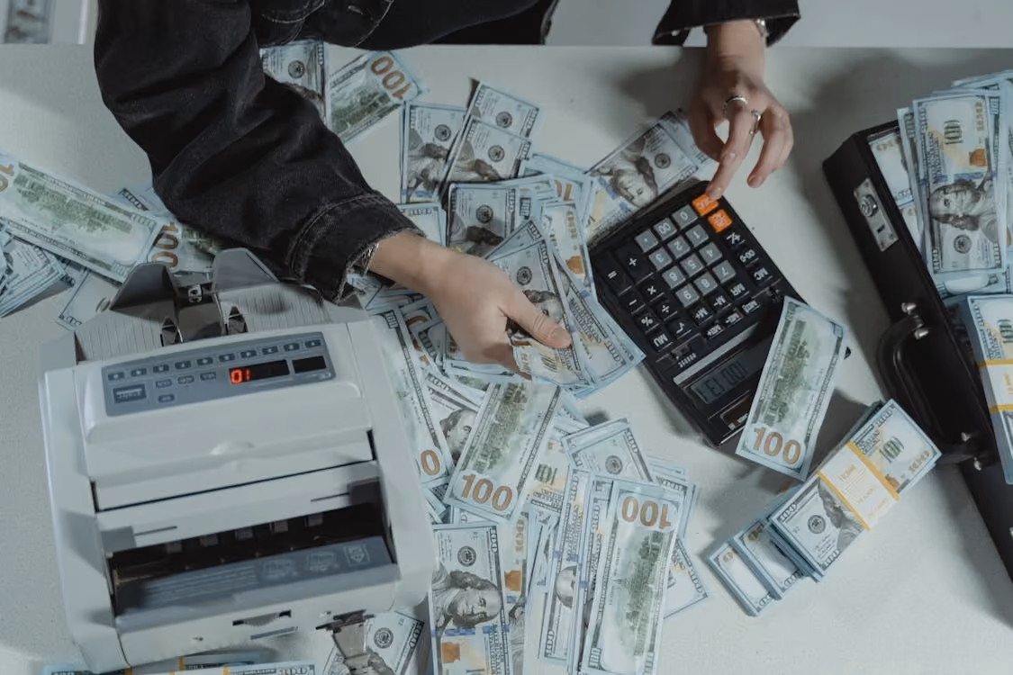 A table sprawled with money being computed
