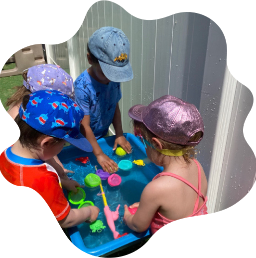 Young girl in a pink sleeveless top and shiny pink cap playing on playground equipment.