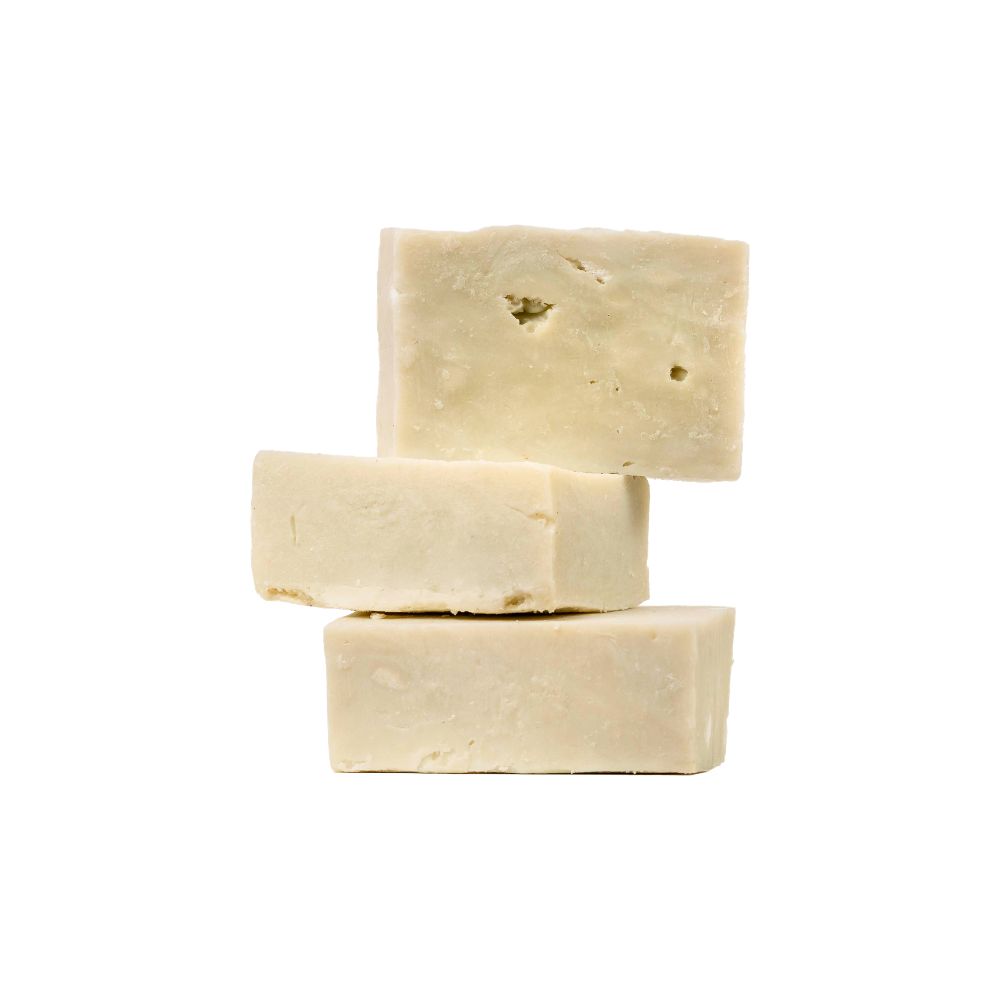 Three rectangular beige soap bars stacked against a white background.