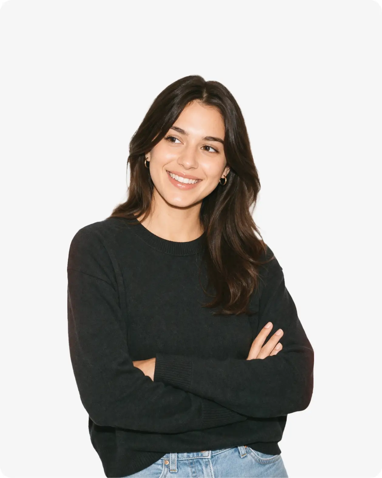 Portrait of a smiling woman with crossed arms wearing a black sweater and jeans.