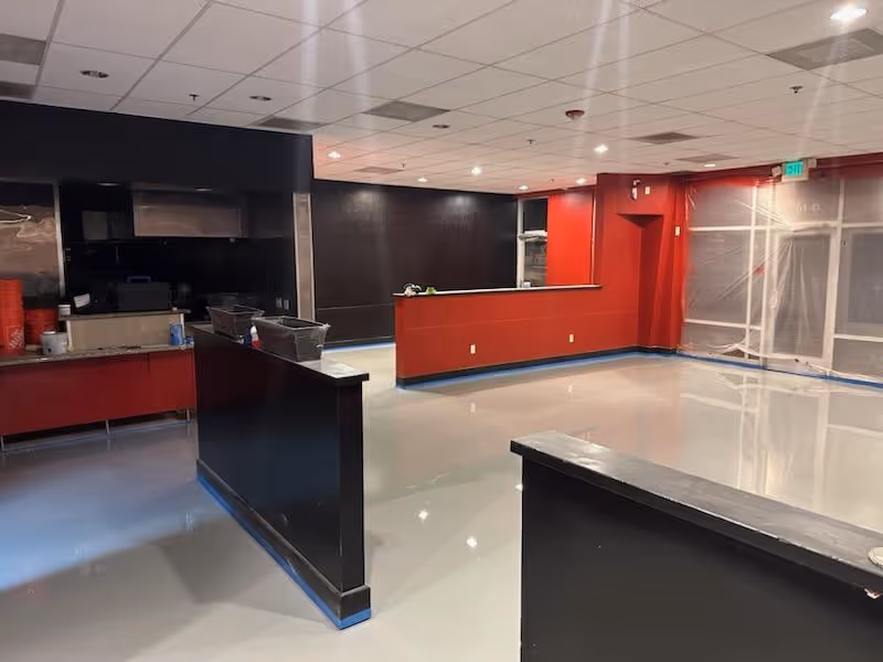 Light gloss floor through a servery and counter area under a suspended ceiling