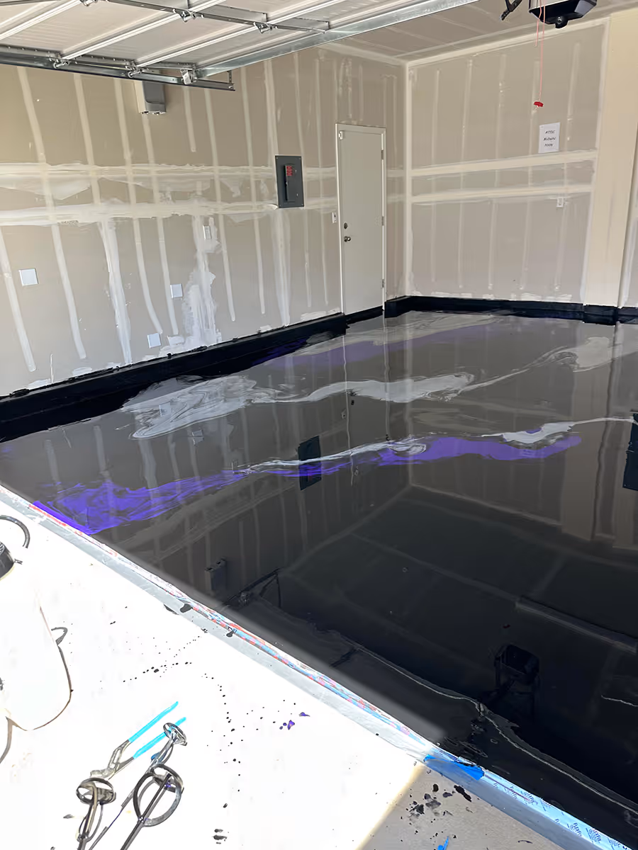 Dark gloss floor laid across a unit with the overhead door open