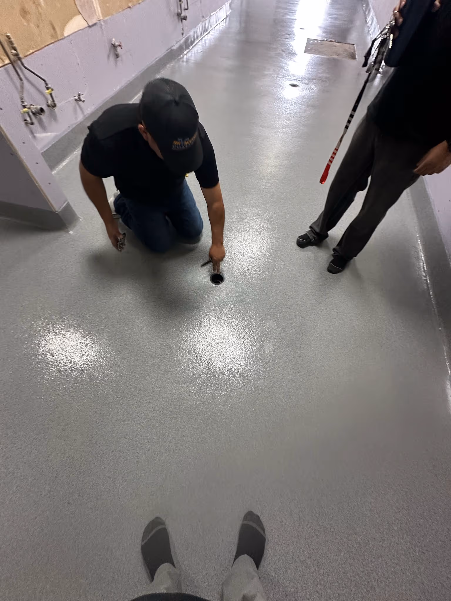 Installers working a freshly applied resin floor coating