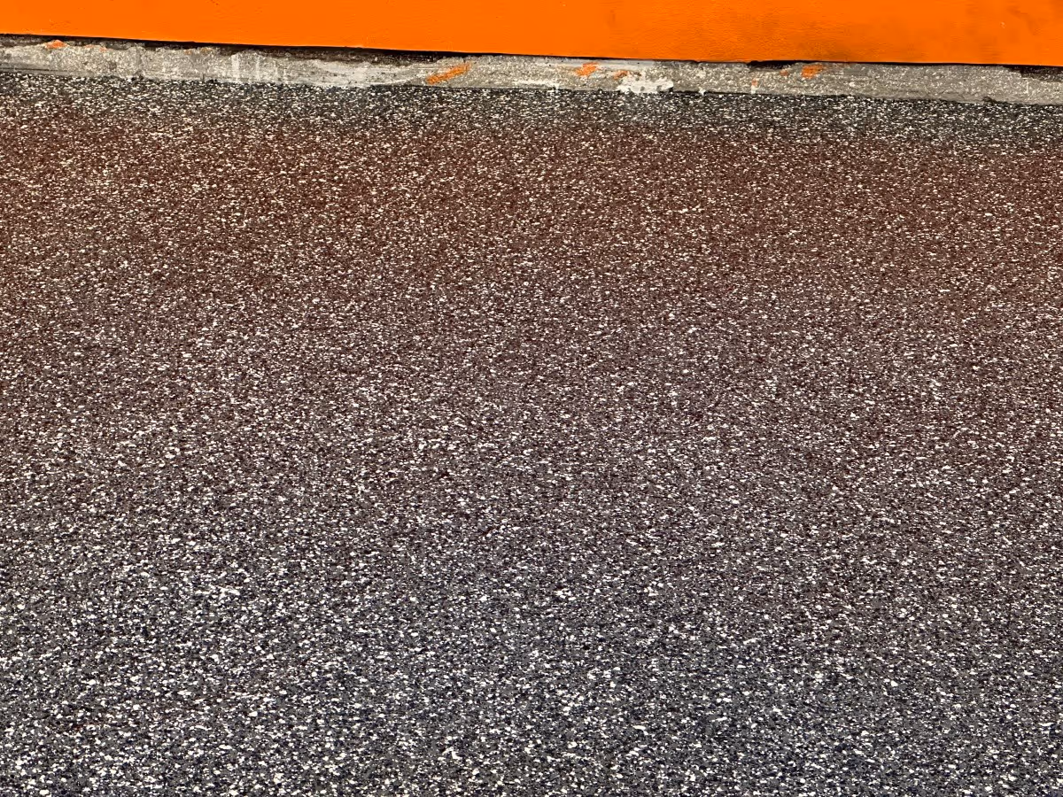 Close-up of a gray and tan epoxy flake garage floor