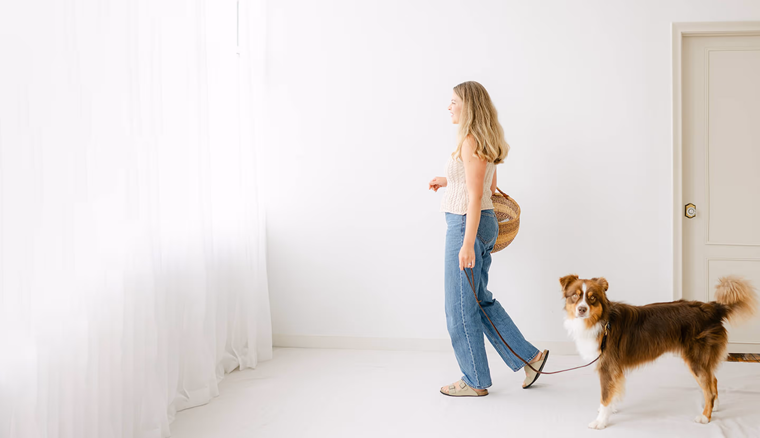Bianca and Moose are walking together in a room. Moose is looking at the camera.