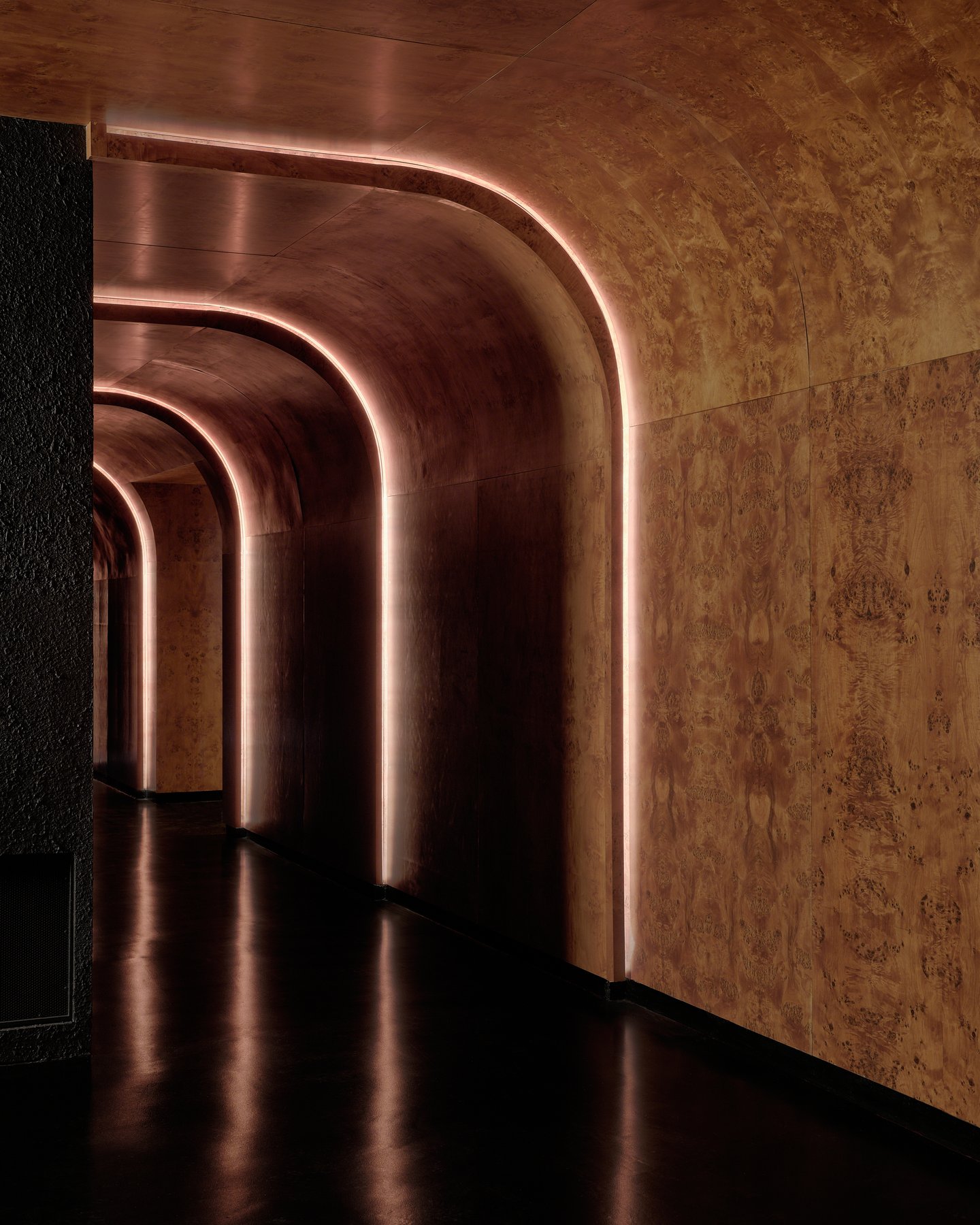 Illuminated curved corridor inside Unveiled in Williamsburg