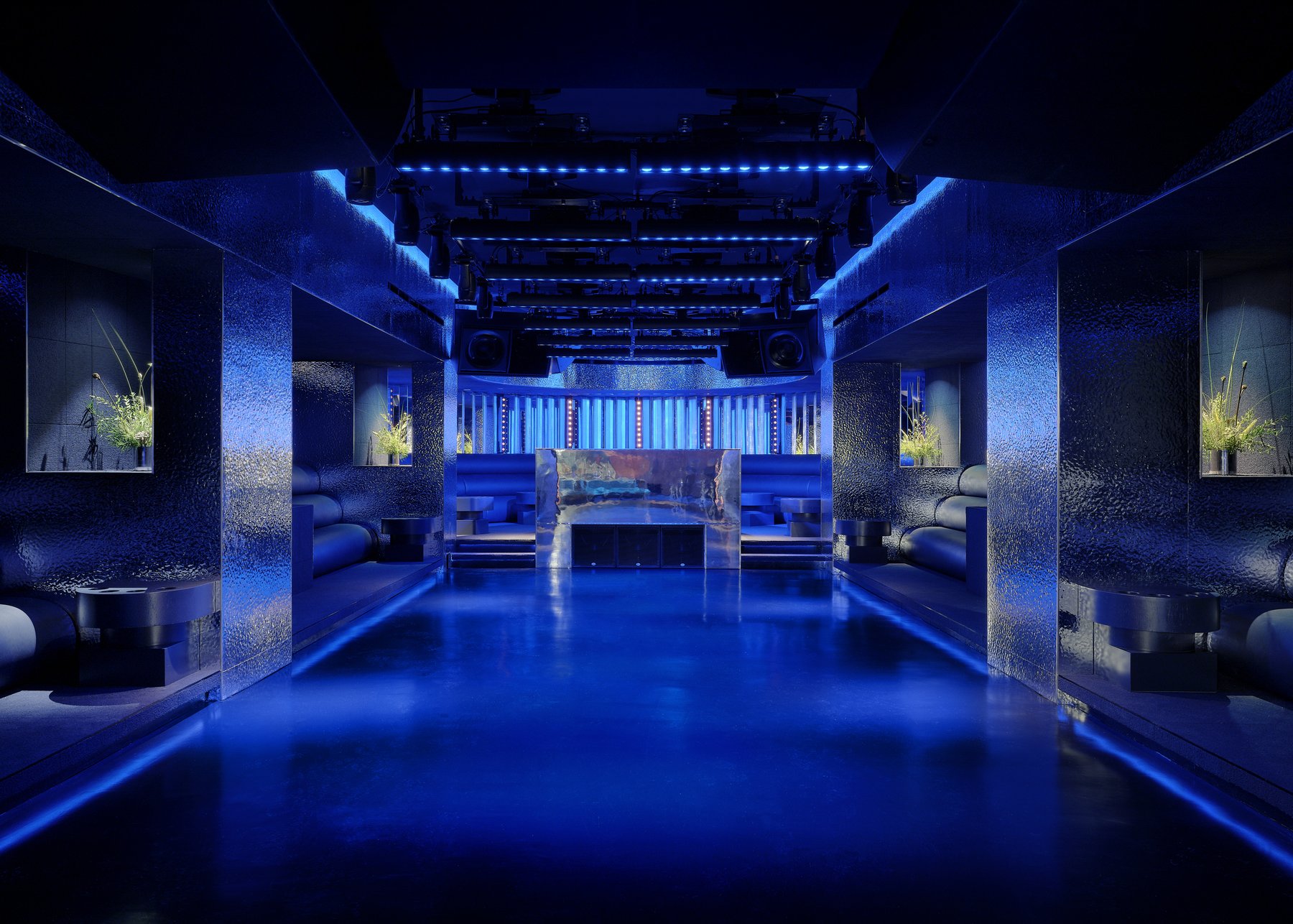Blue-lit main room at Unveiled in Williamsburg