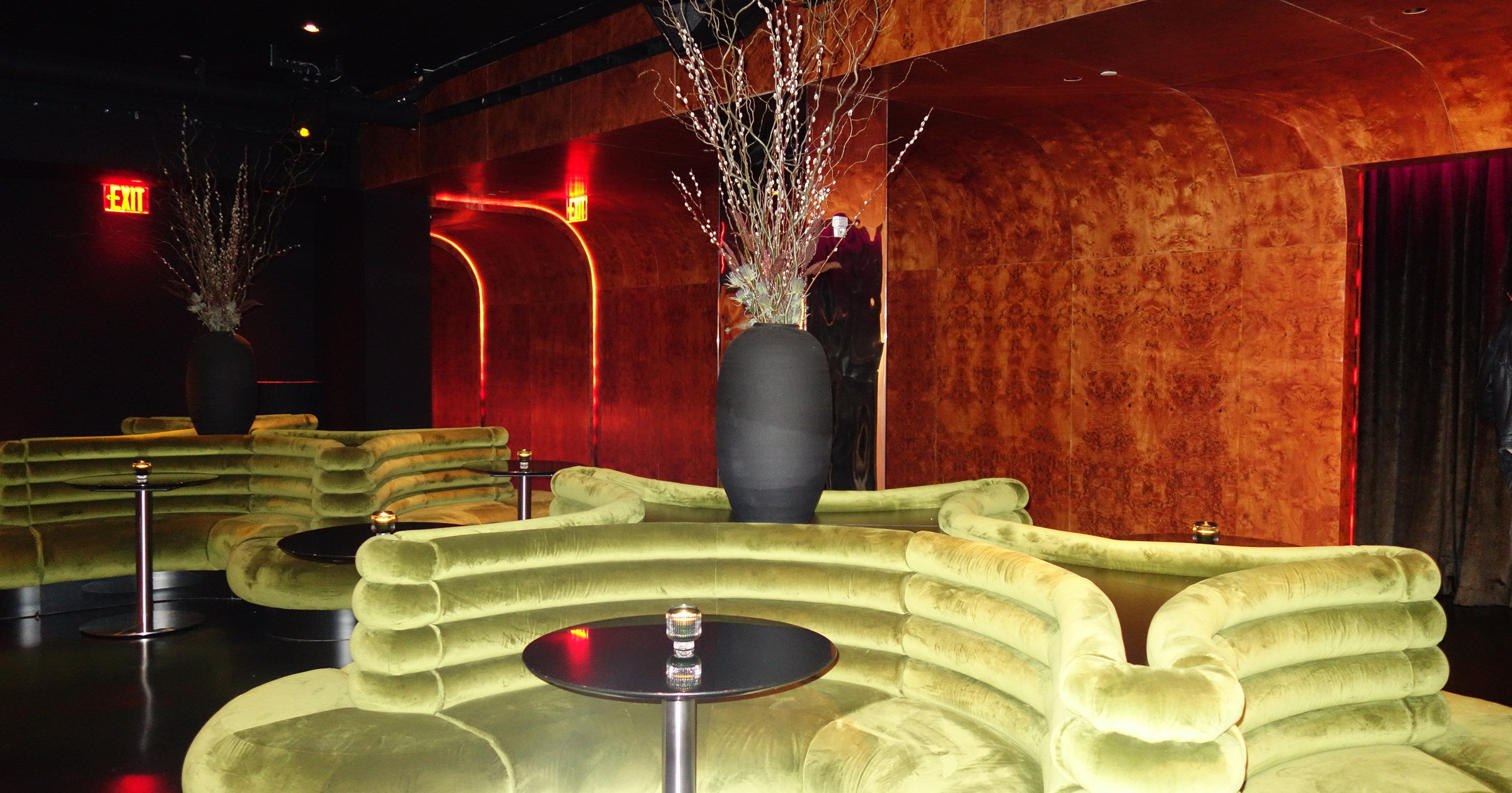 Warm sculptural lounge seating and cocktail tables arranged inside Unveiled.