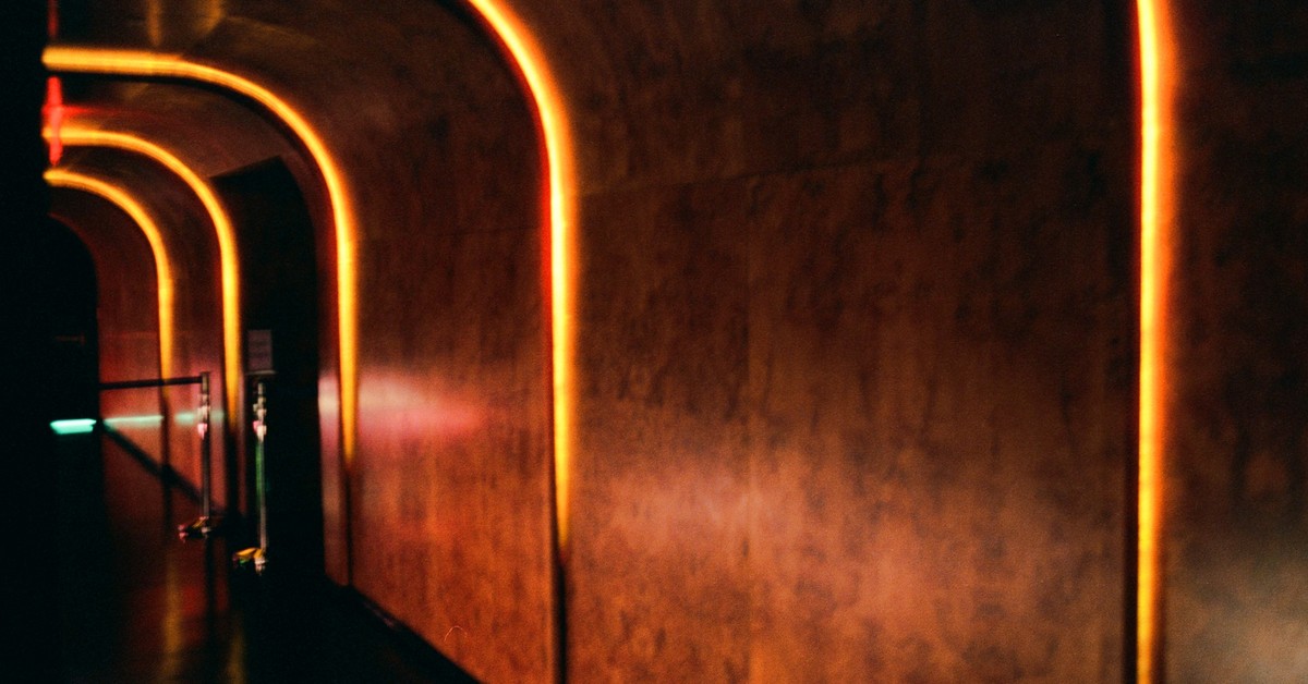 Warm arched corridor with illuminated trim inside Unveiled in Williamsburg, Brooklyn.