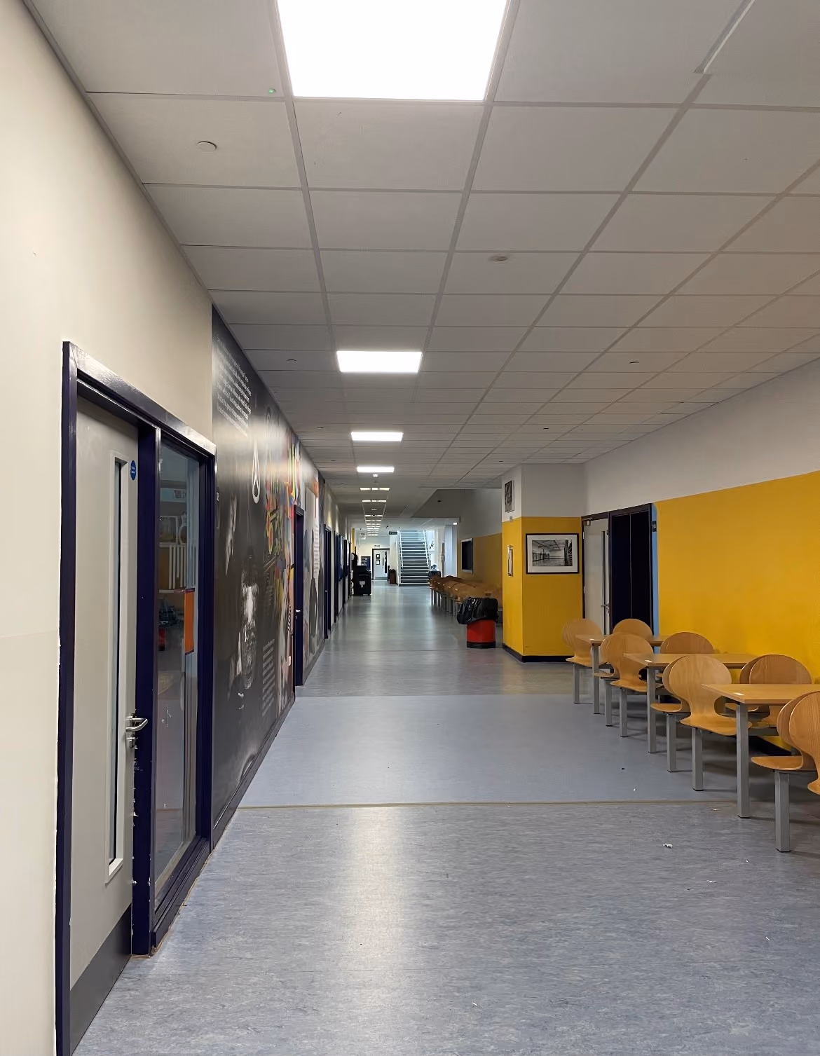 School corridor with new LED panel lighting installed in the ceiling